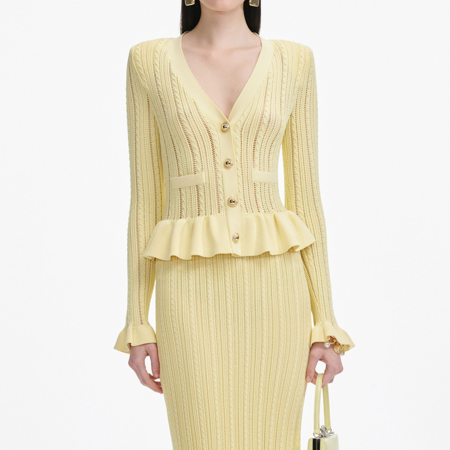 A close up of a woman wearing the Yellow Knit Peplum Midi Dress