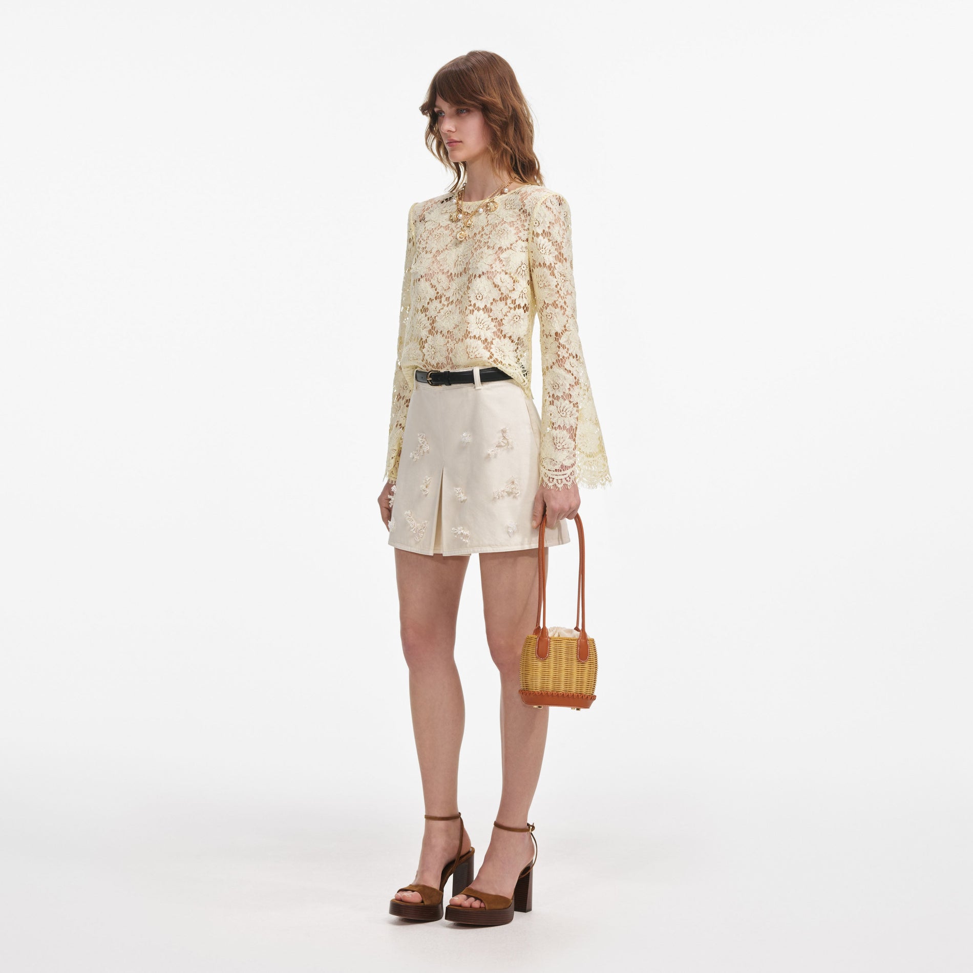 Side view of a woman wearing the Yellow Lace Fluted Sleeve Top