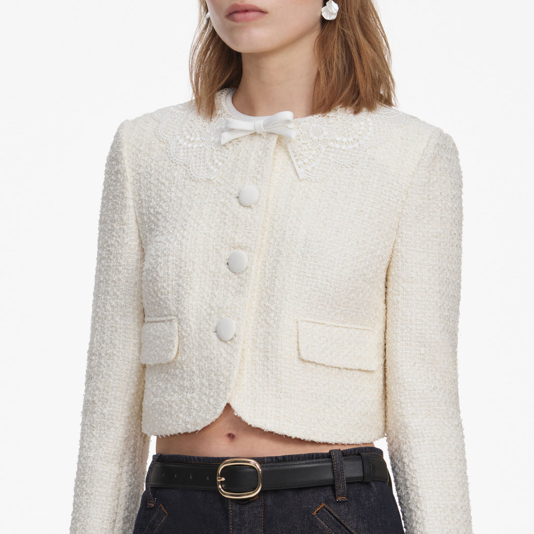 A close up of a woman wearing the Cream Boucle Lace Collar Jacket