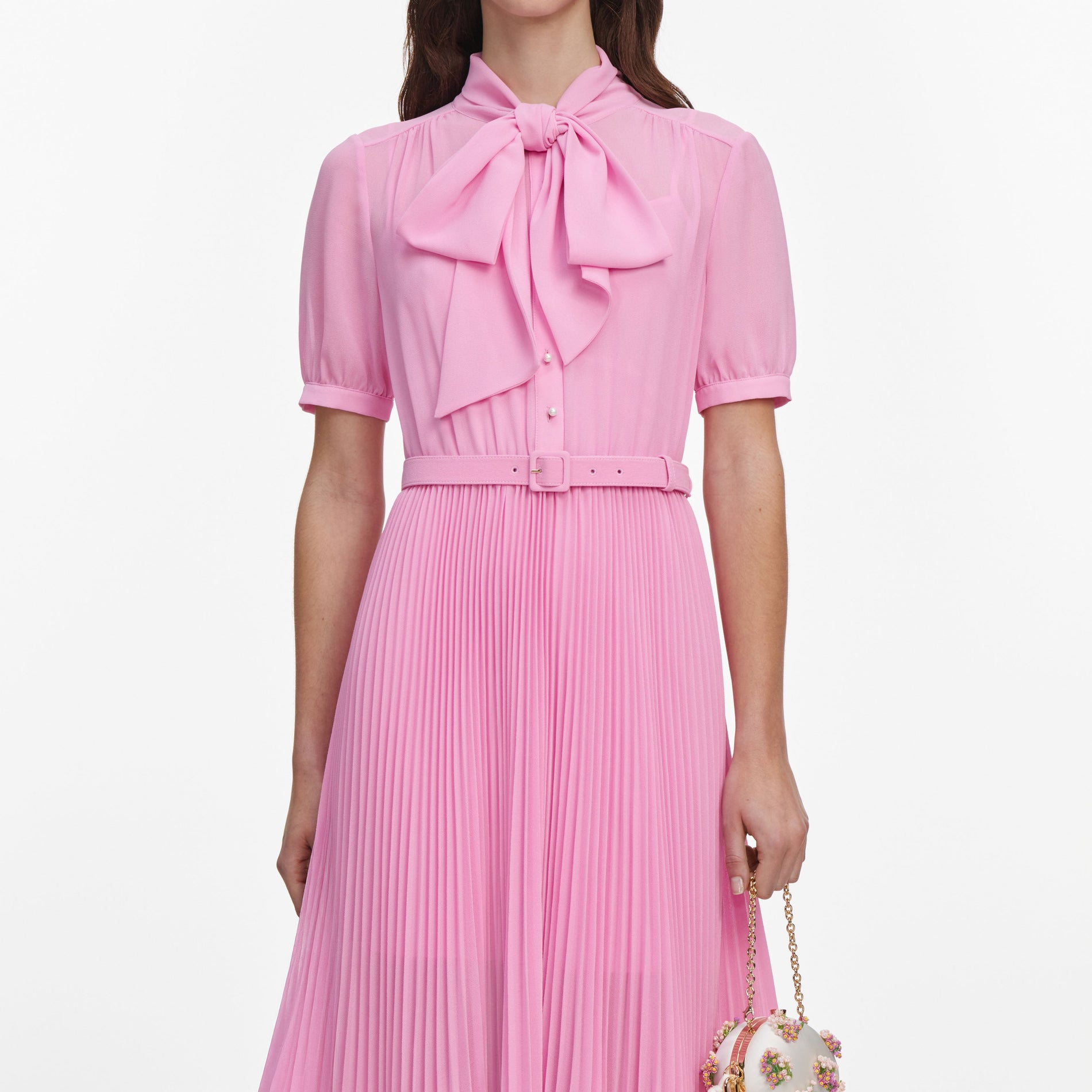 A close up of a woman wearing the Pink Georgette Tie Neck Midi Dress