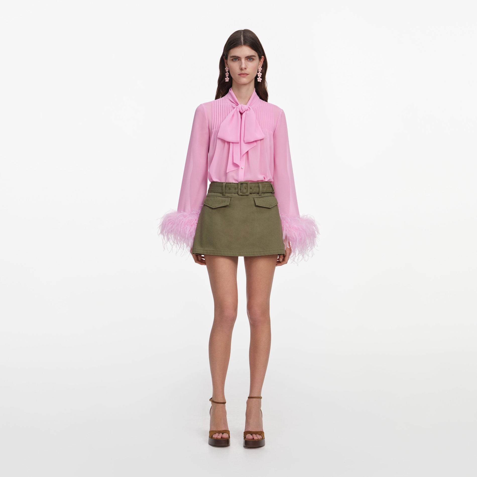 Front view of a woman wearing the Pink Georgette Feather Cuff Blouse