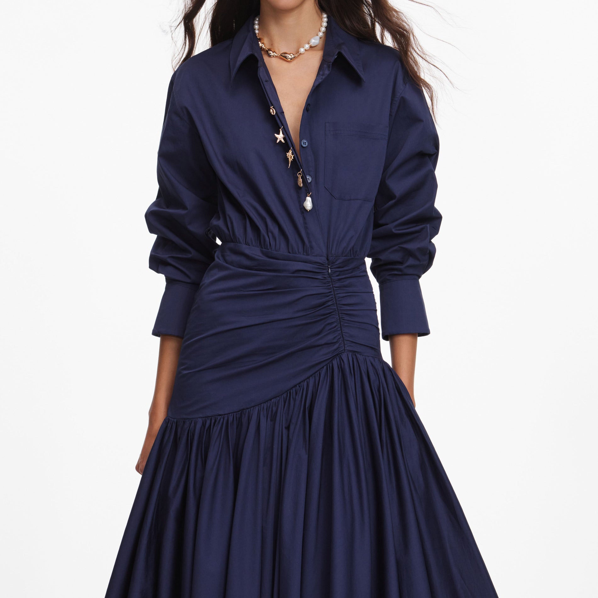 A close up of a woman wearing the Navy Cotton Asymmetric Midi Dress