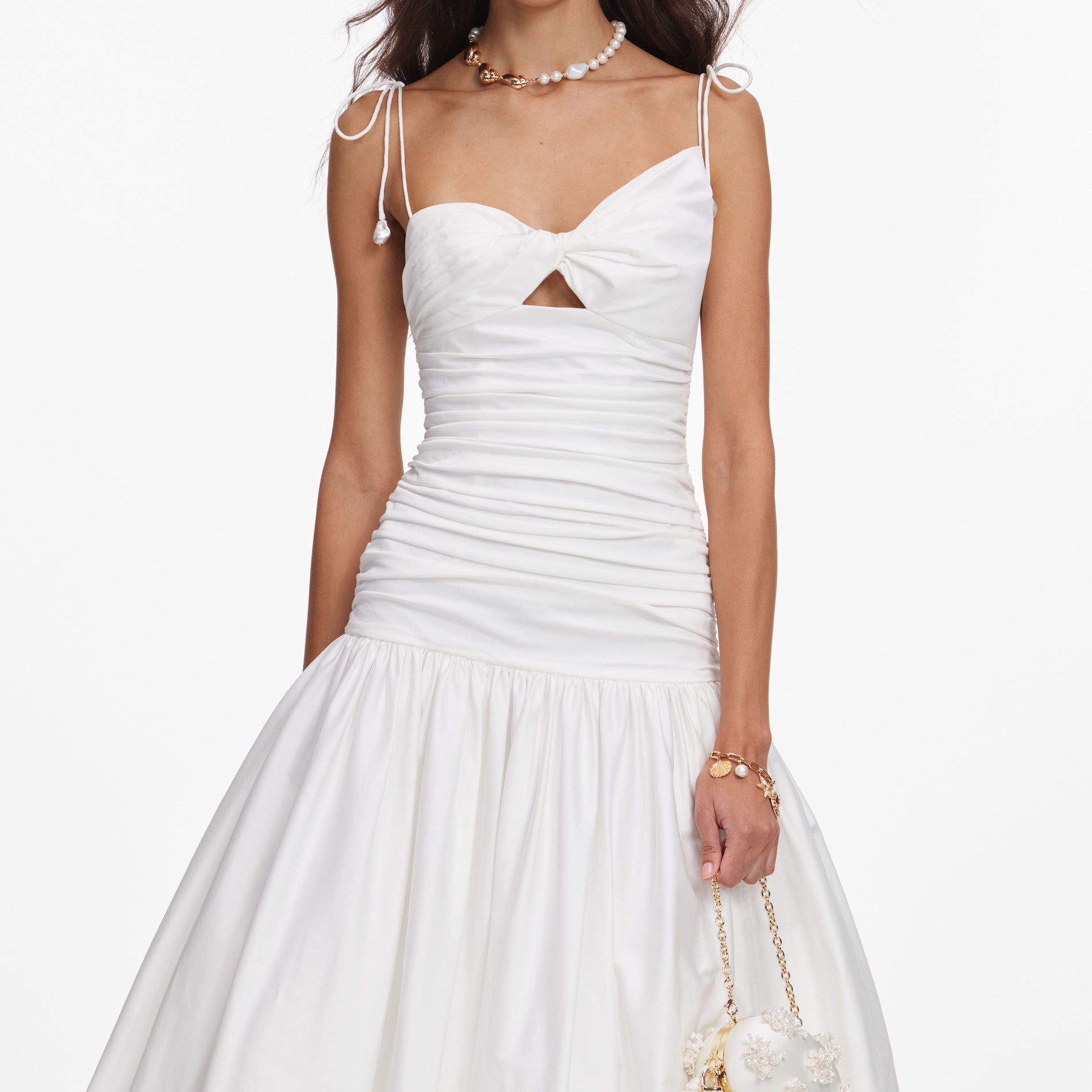 A close up of a woman wearing the White Cotton Gathered Midi Dress