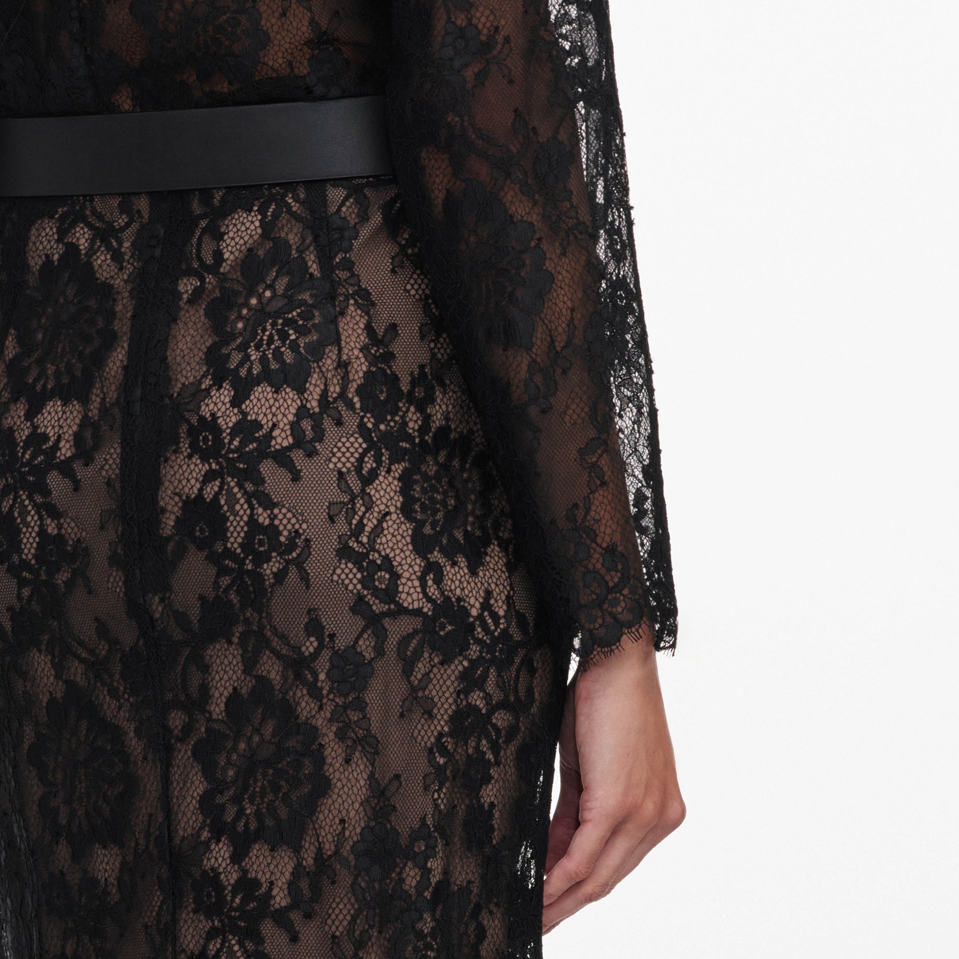 A close up of a woman wearing the Black Lace Midi Skirt