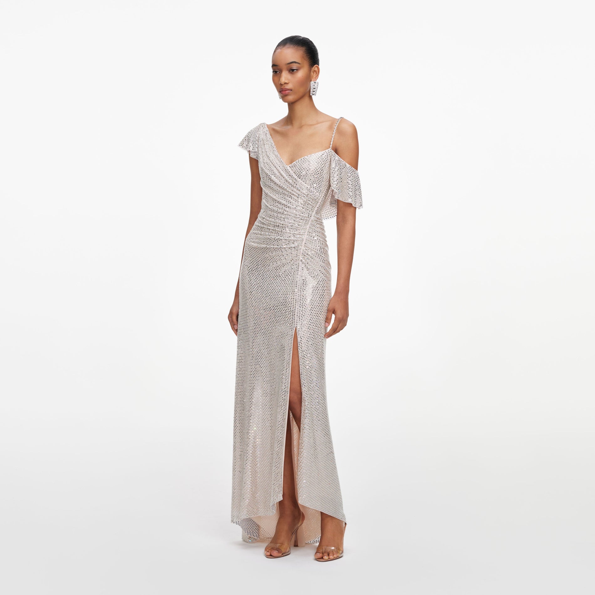 Side view of a woman wearing the Champagne Rhinestone Ruffle Draped Maxi Dress