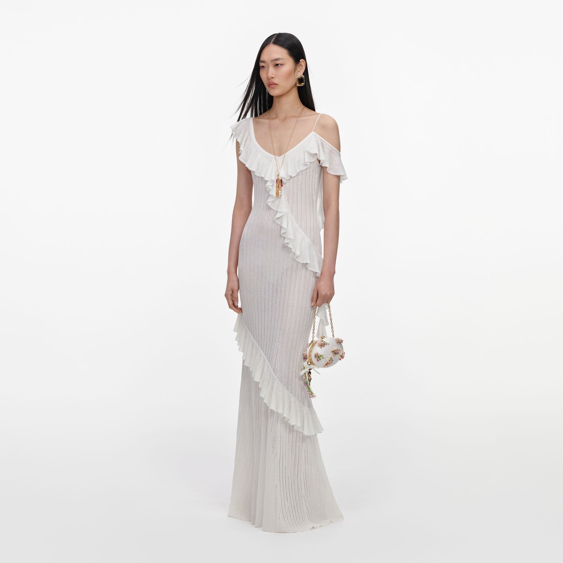 Side view of a woman wearing the White Ruffle Knit Maxi Dress