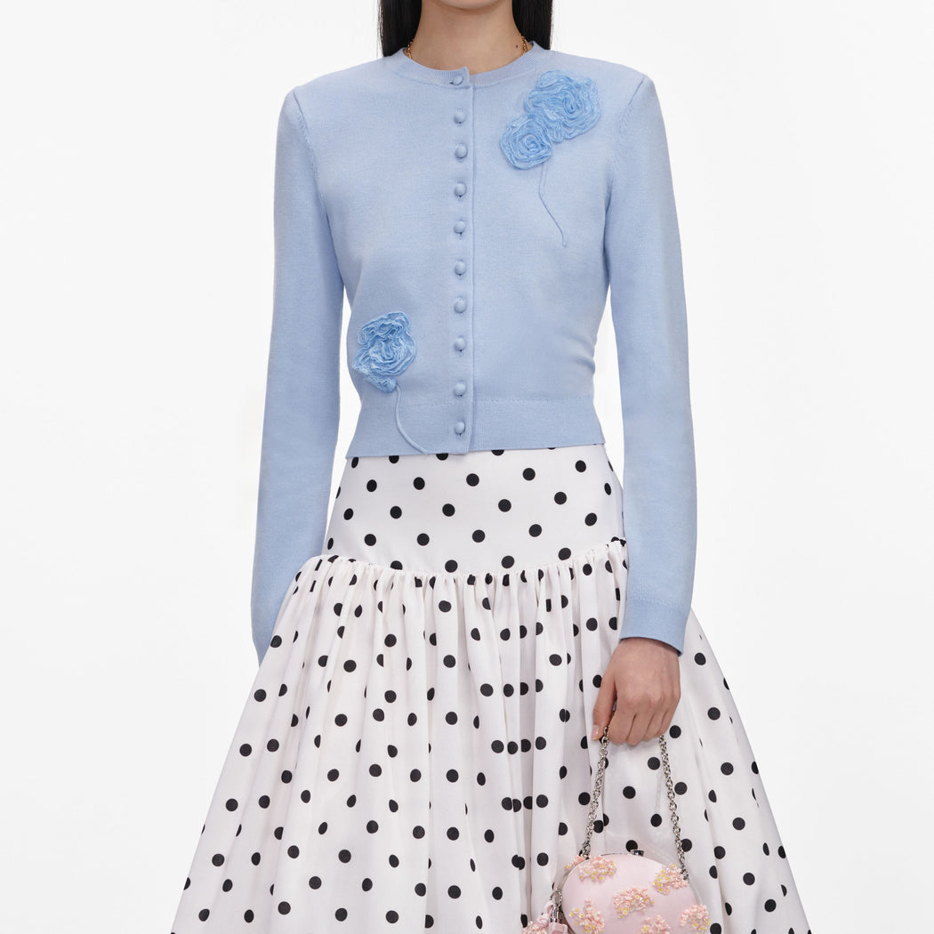 A close up of a woman wearing the Blue Flower Knit Cardigan