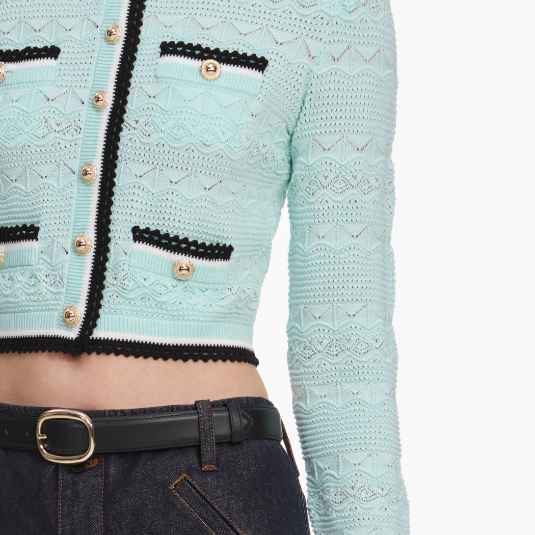 A close up of a woman wearing the Mint Pointelle Knit Cardigan