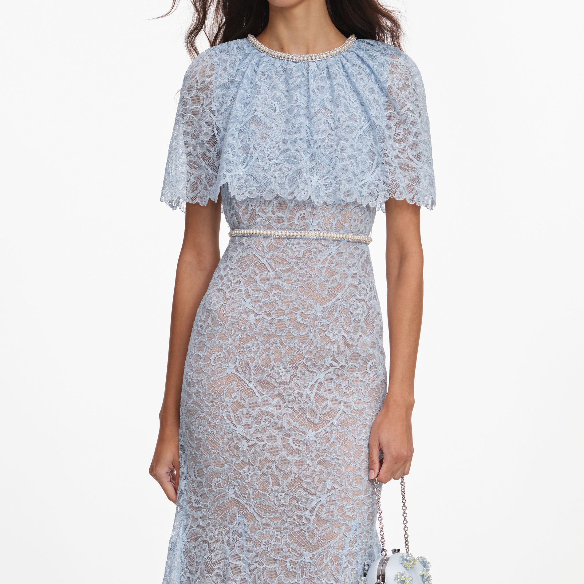 A close up of a woman wearing the Blue Lace Cape Midi Dress