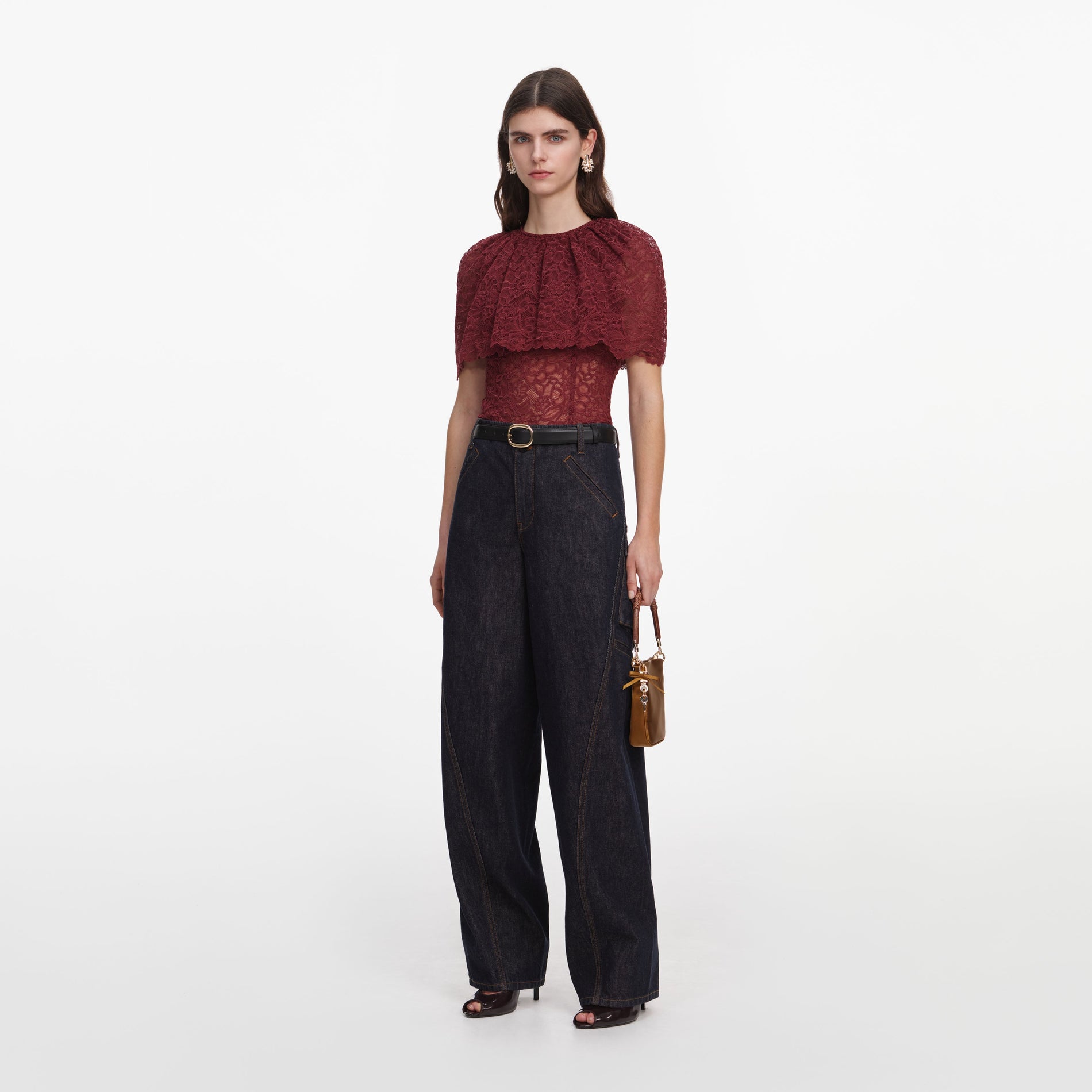 Side view of a woman wearing the Burgundy Lace Cape Top