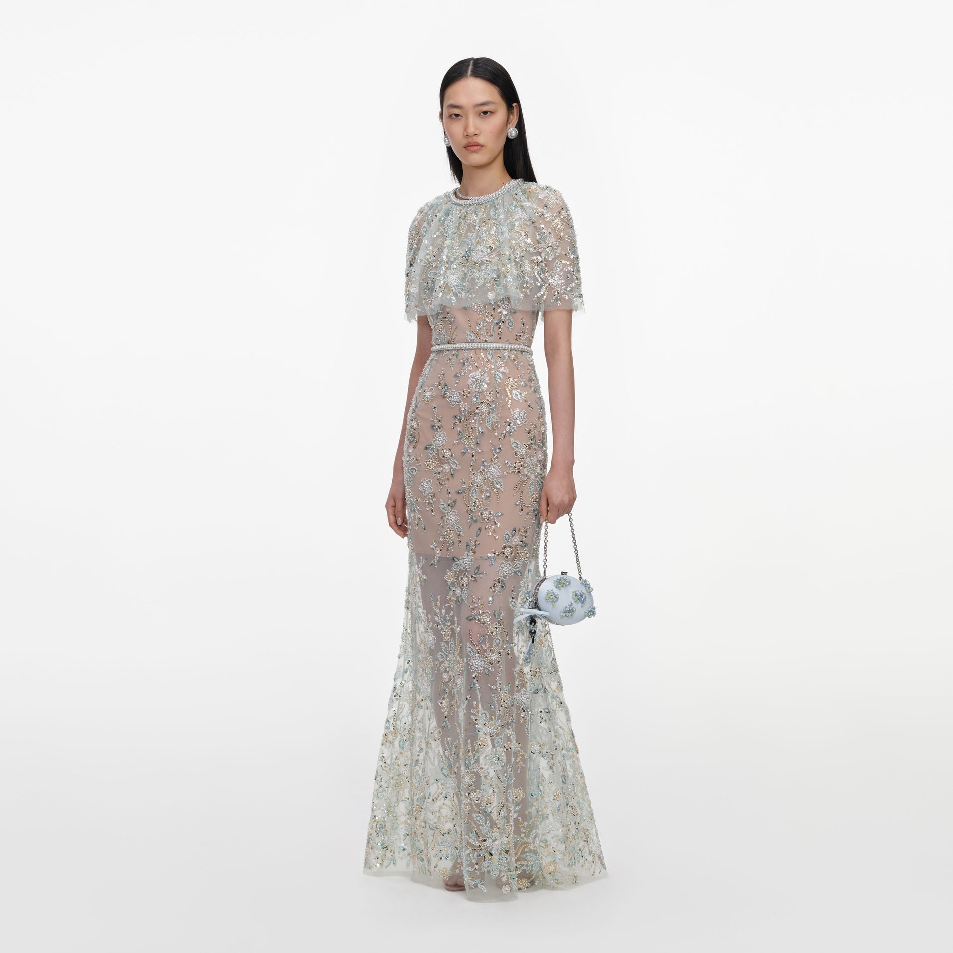 Side view of a woman wearing the Mint Embellished Cape Maxi Dress