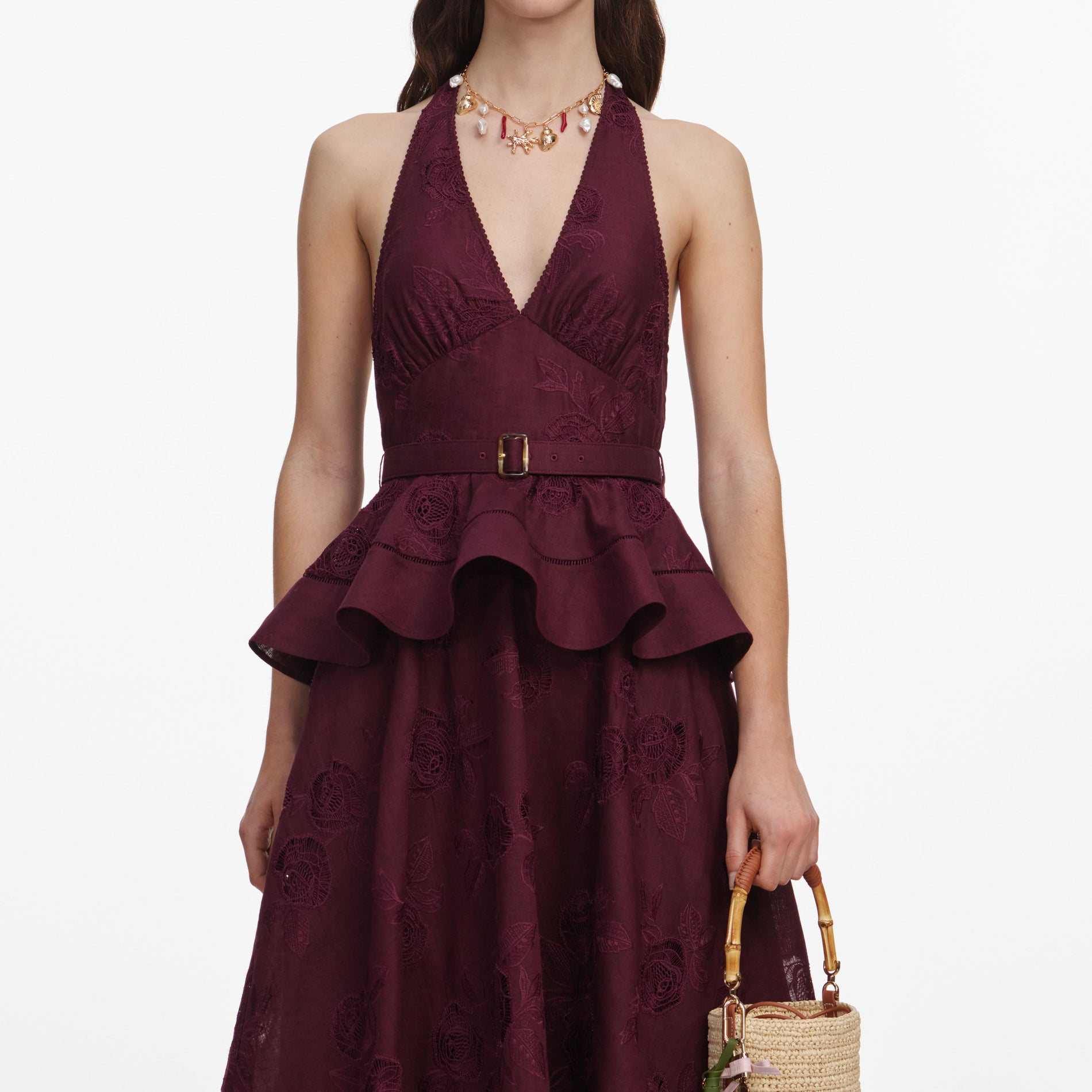 A close up of a woman wearing the Plum Linen Blend Peplum Midi Dress