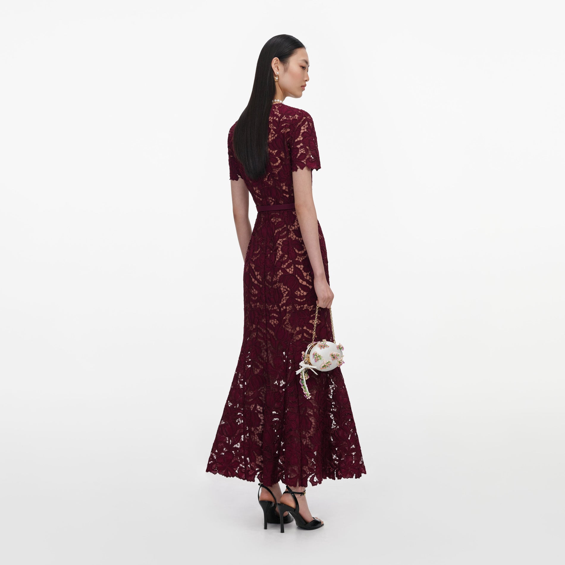 Back view of a woman wearing the Burgundy Lace Midi Dress