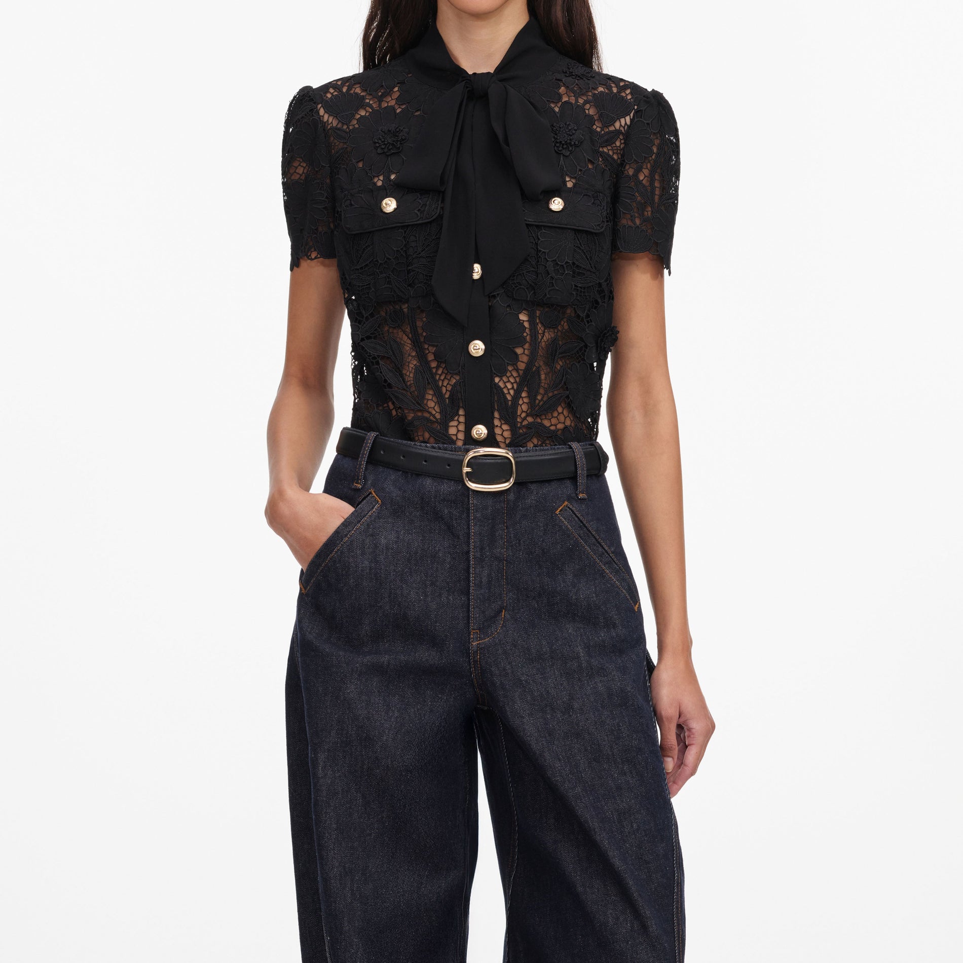 A close up of a woman wearing the Black Lace Tie Neck Top