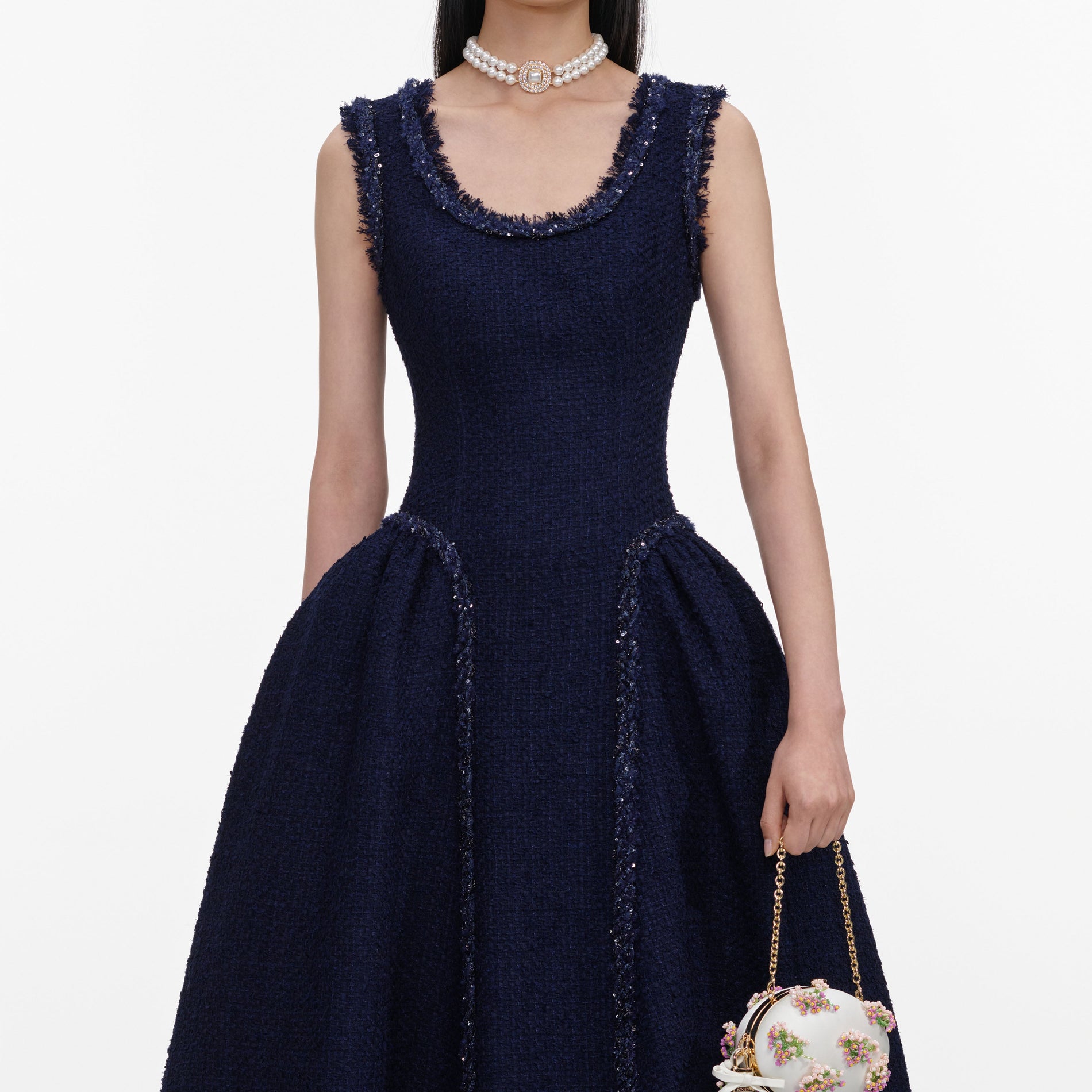 A close up of a woman wearing the Navy Boucle Midi Dress