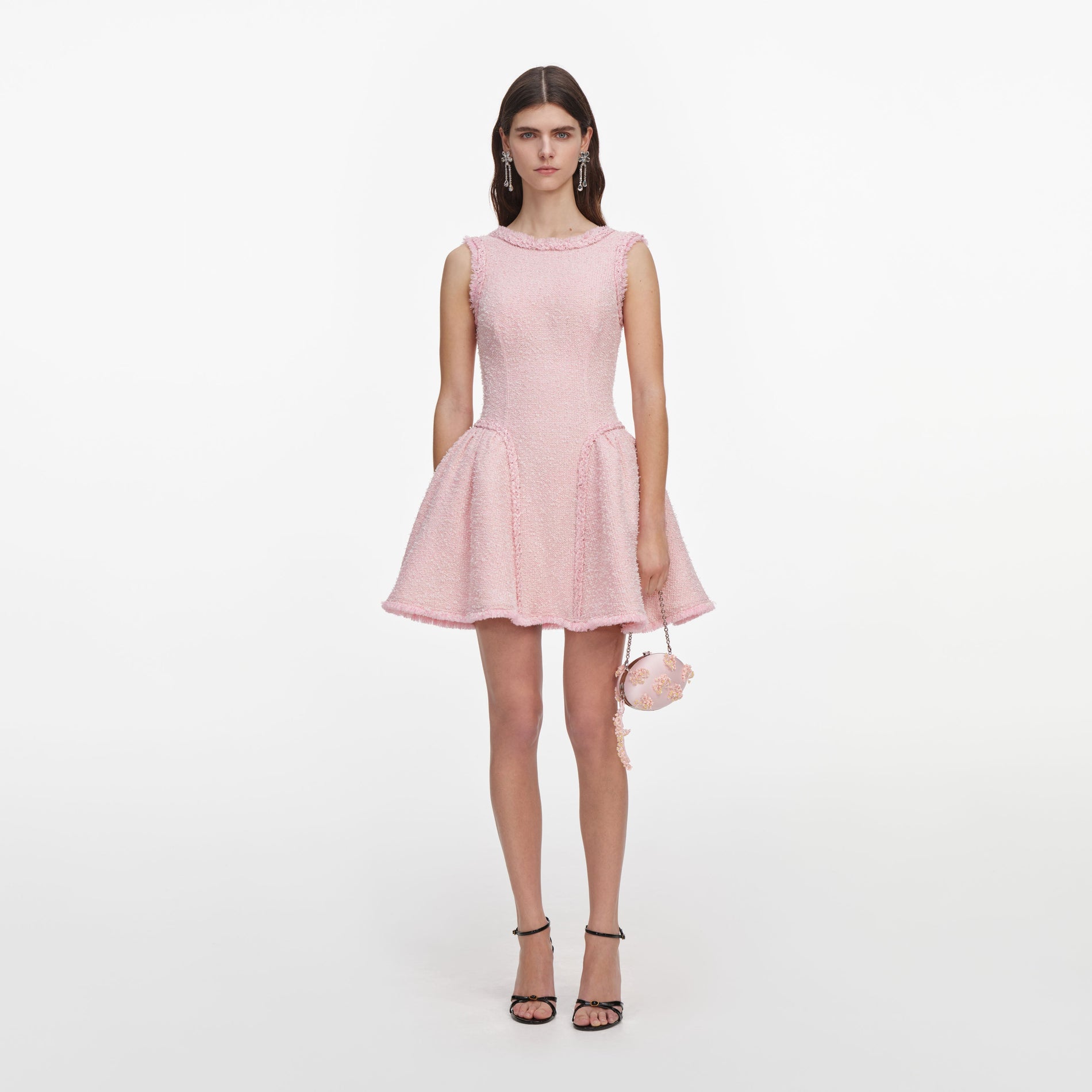 Front view of a woman wearing the Pink Boucle Sleeveless Mini Dress