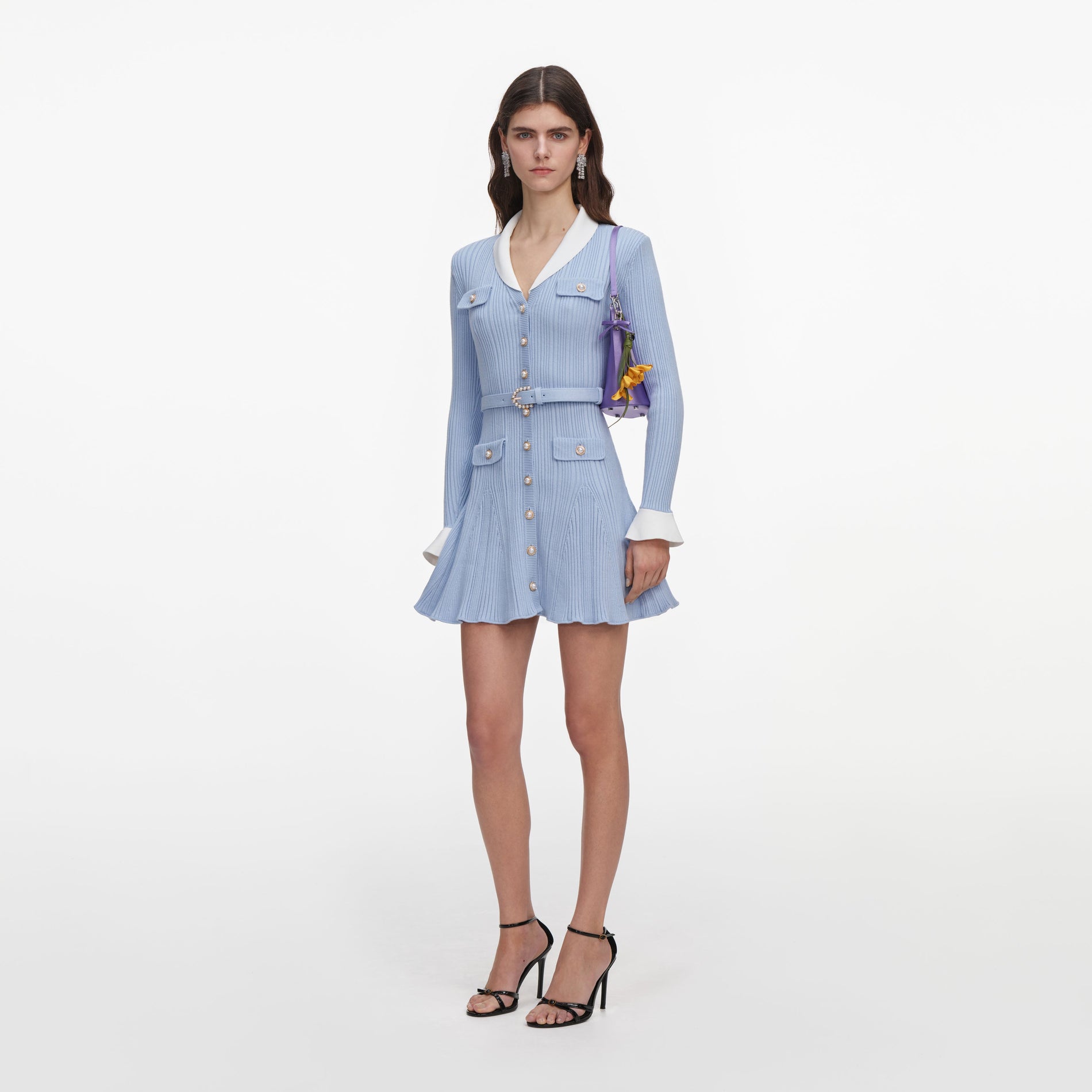 Side view of a woman wearing the Blue Ribbed Knit Mini Dress