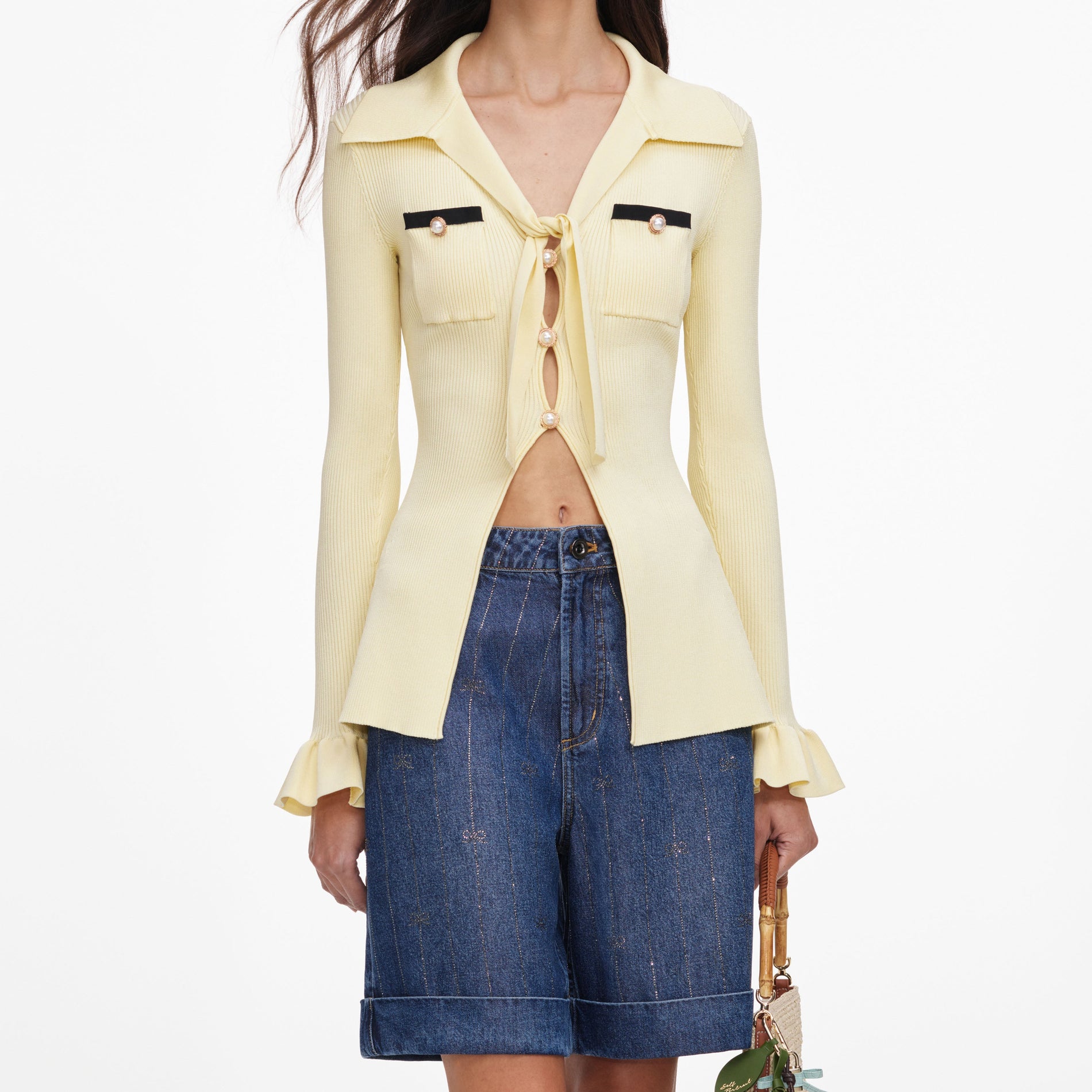 A close up of a woman wearing the Yellow Viscose Knit Tie Top