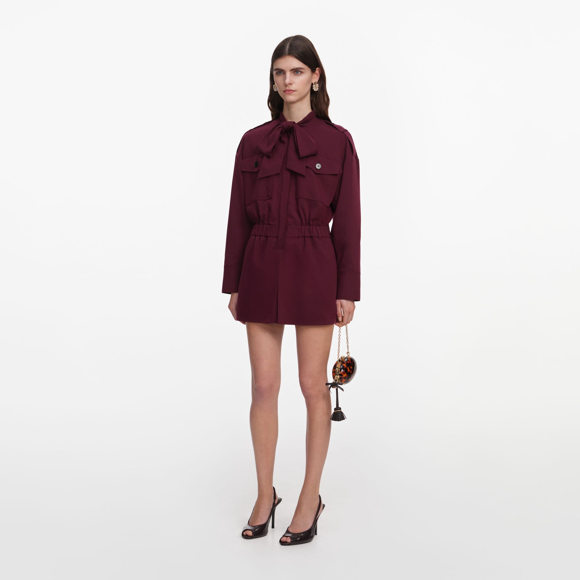 Side view of a woman wearing the Plum Twill Tie Neck Playsuit