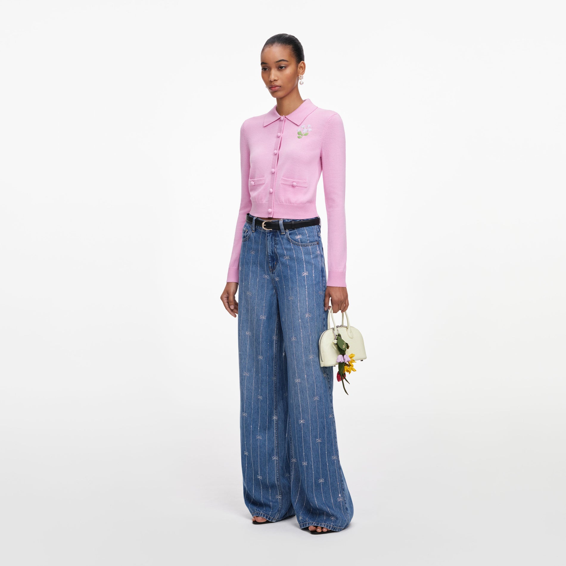 Side view of a woman wearing the Pink Flower Embroidered Knit Cardigan