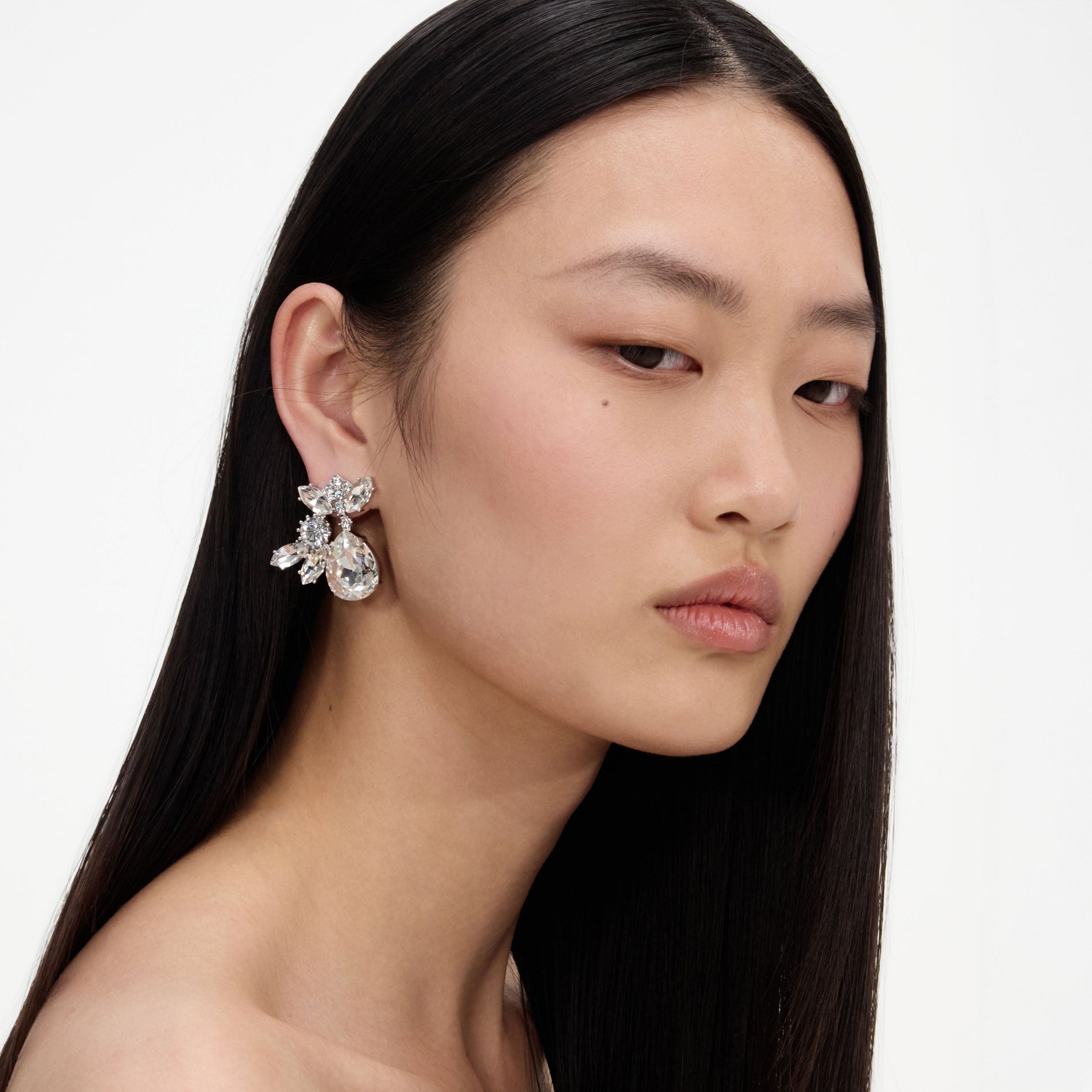 A close up of a woman wearing the Multi Crystal Cluster Earrings