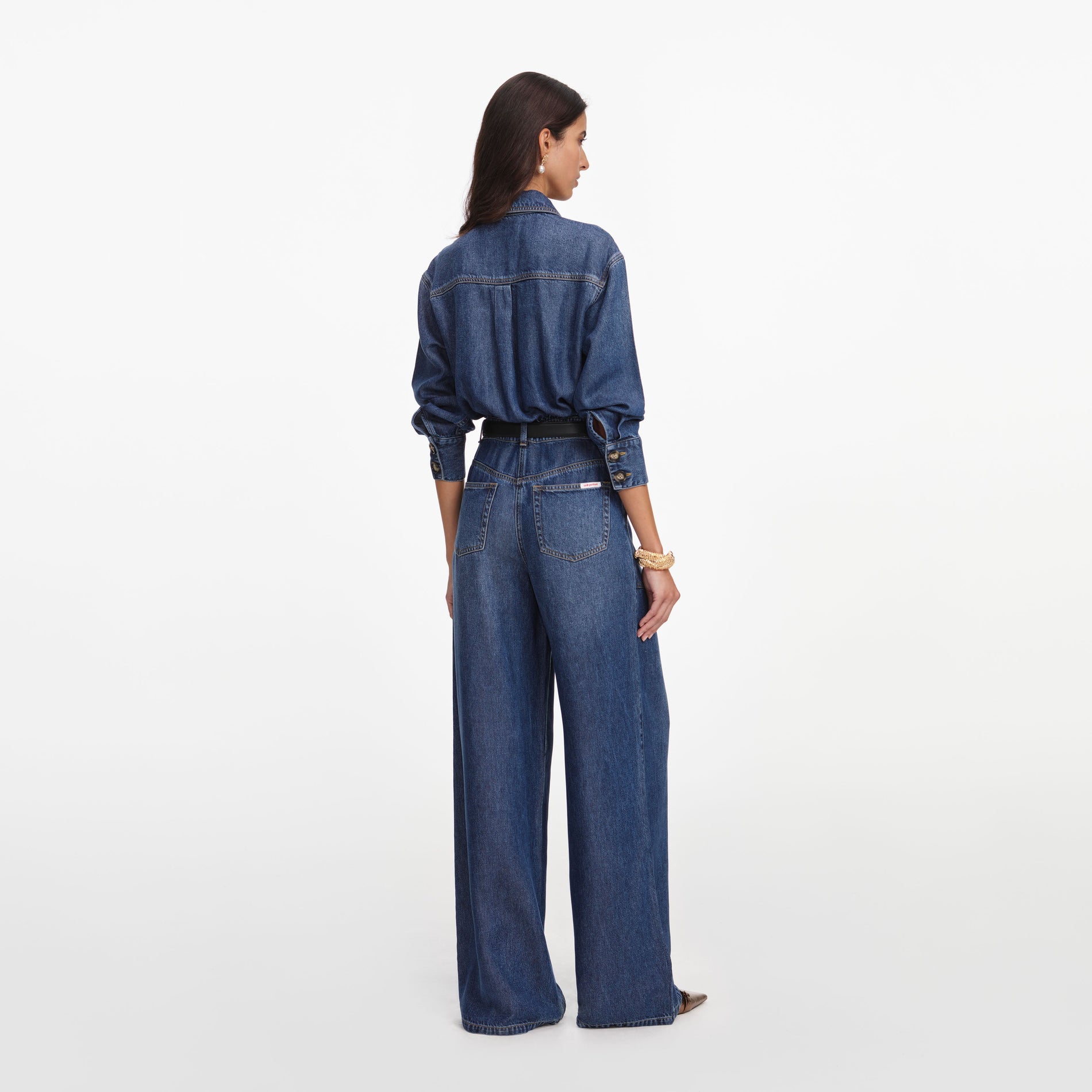 Back view of a woman wearing the Denim Relaxed Fit Jumpsuit