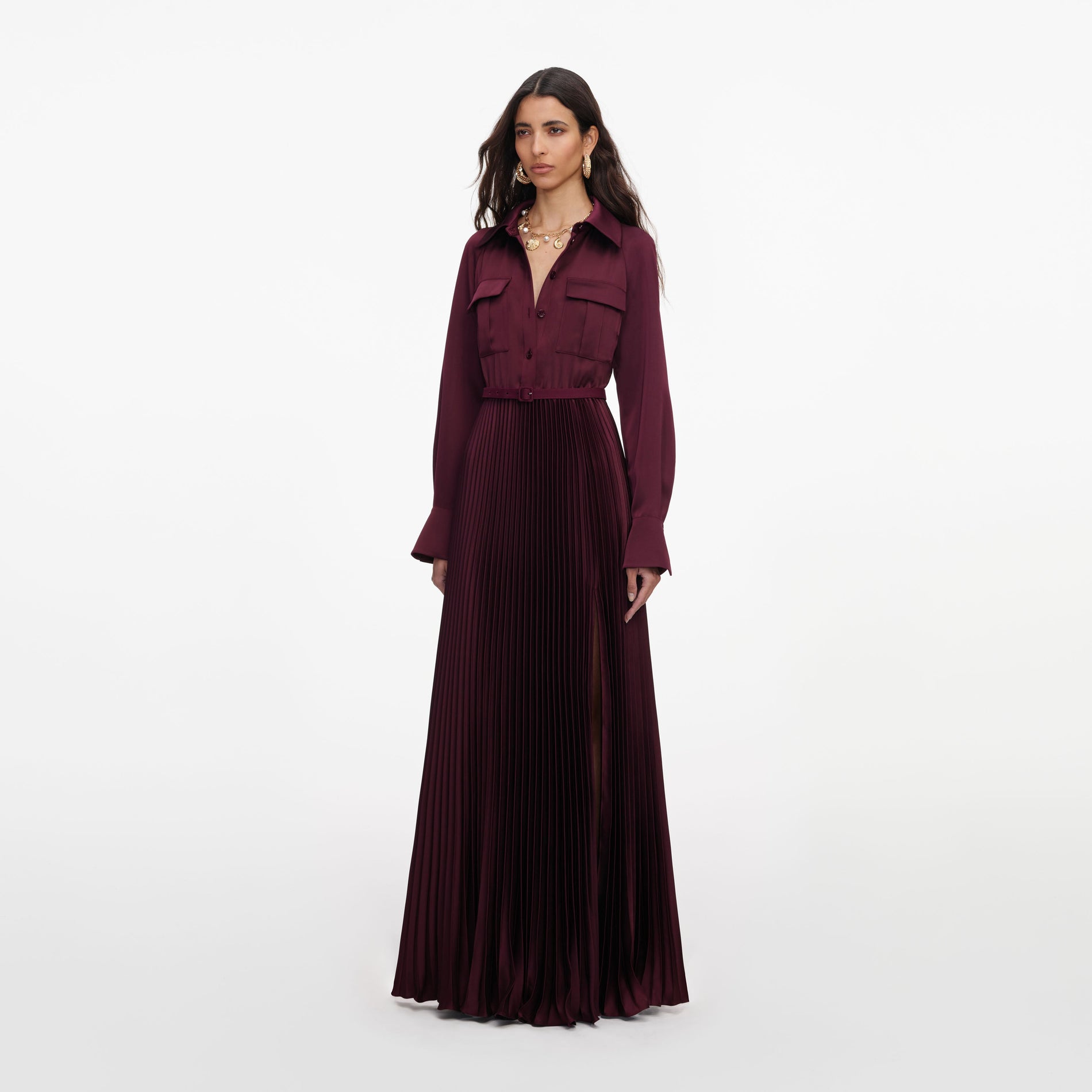 Side view of a woman wearing the Plum Satin Pleated Maxi Dress