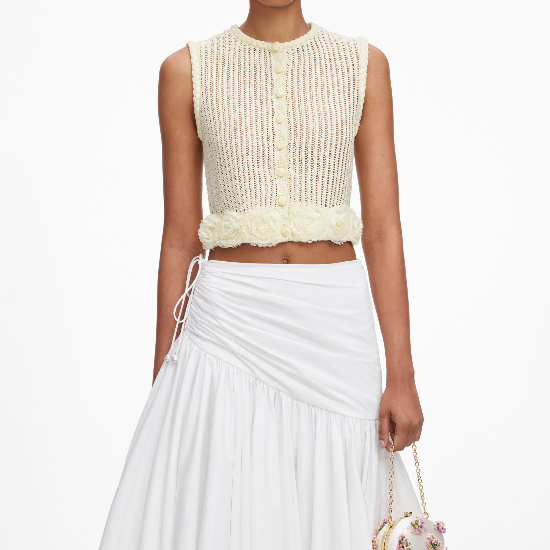 A close up of a woman wearing the Yellow Crochet Flower Knit Top