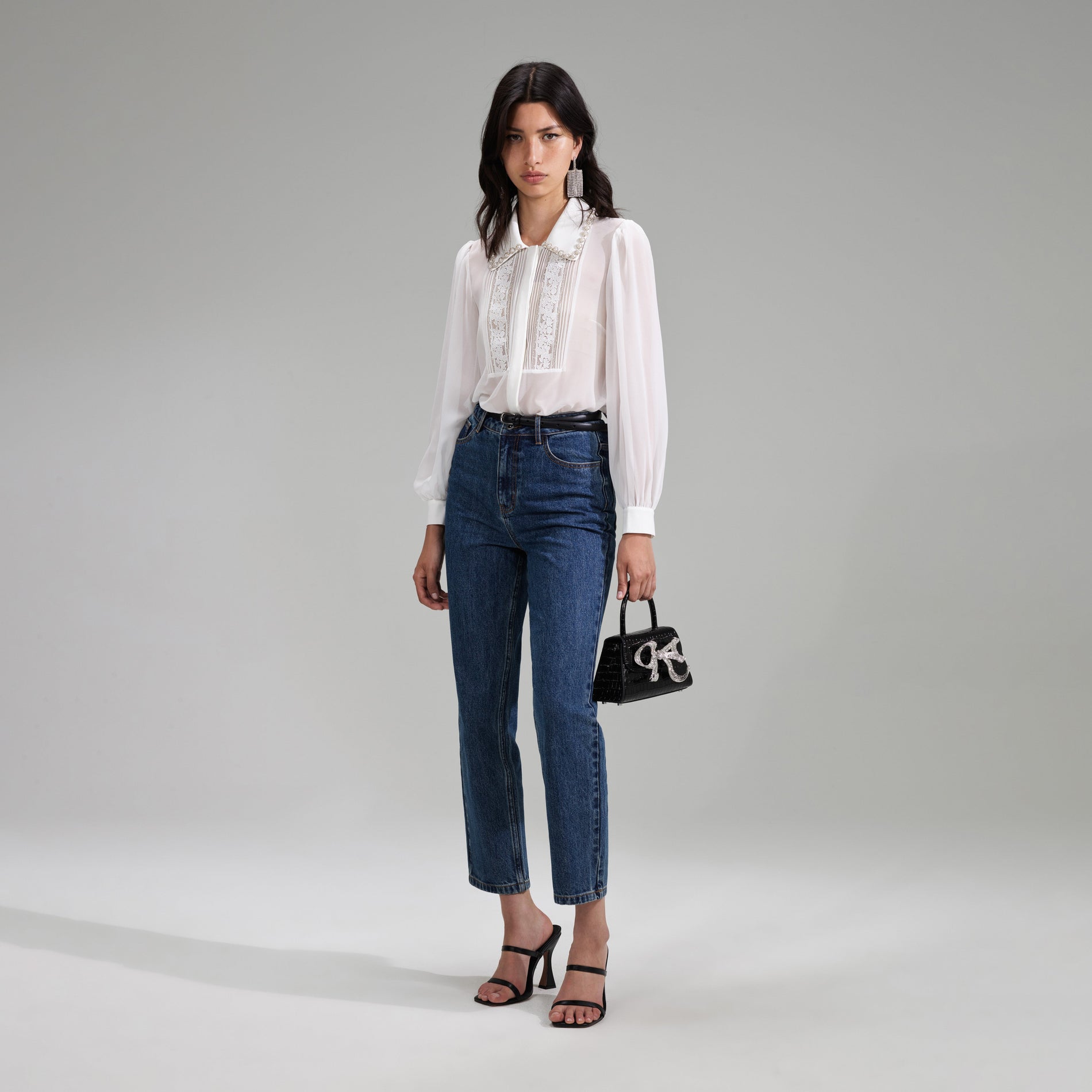 A woman wearing the White Chiffon Rhinestone Detail Top