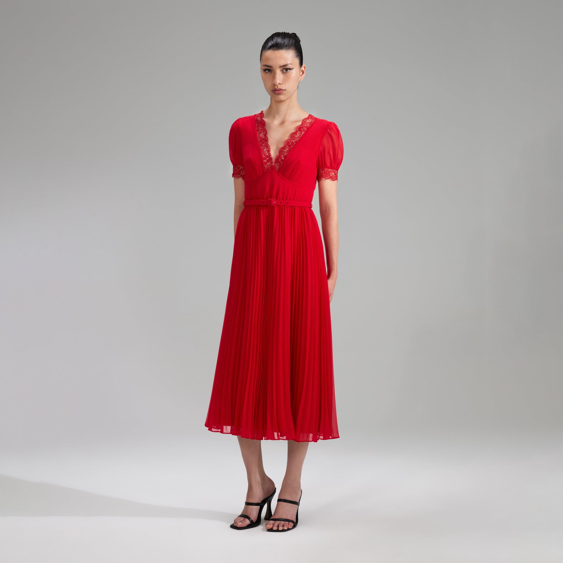 A woman wearing the Red Chiffon Midi Dress Lace Detail