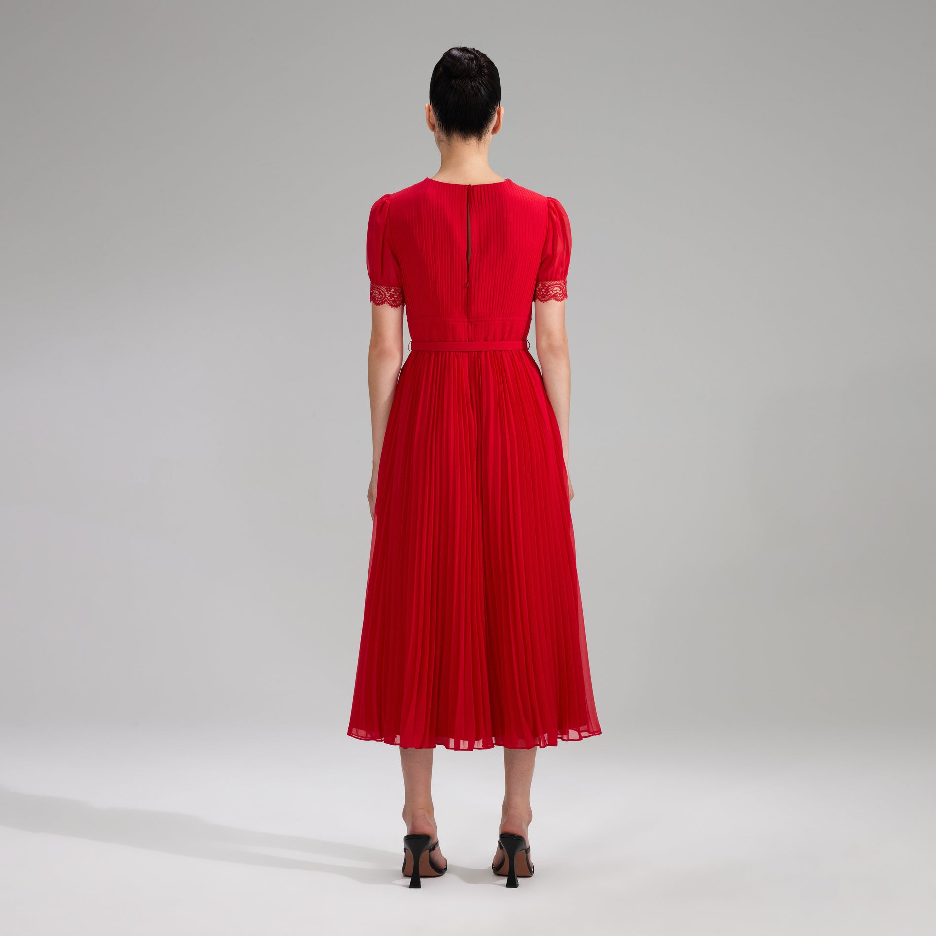 A woman wearing the Red Chiffon Midi Dress Lace Detail