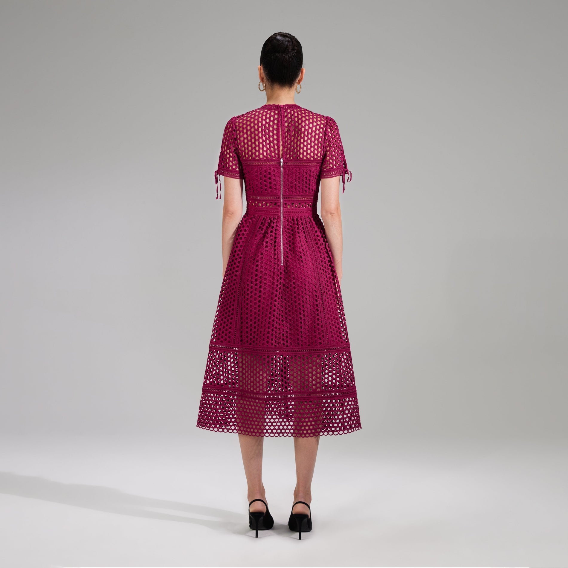 A woman wearing the Burgundy Lace Midi Dress