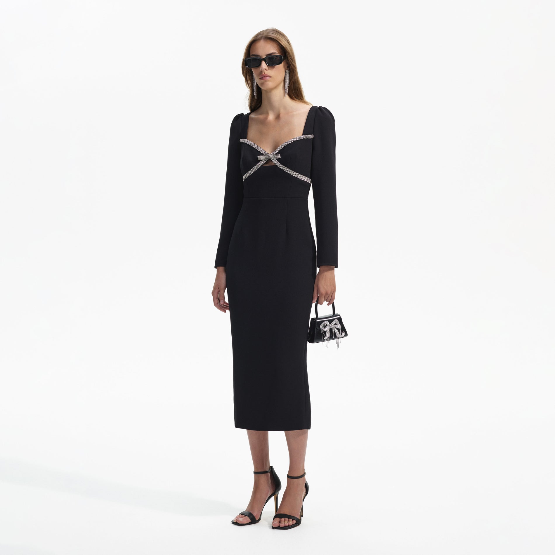 Side view of a woman wearing the Black Diamante Bow Midi Dress