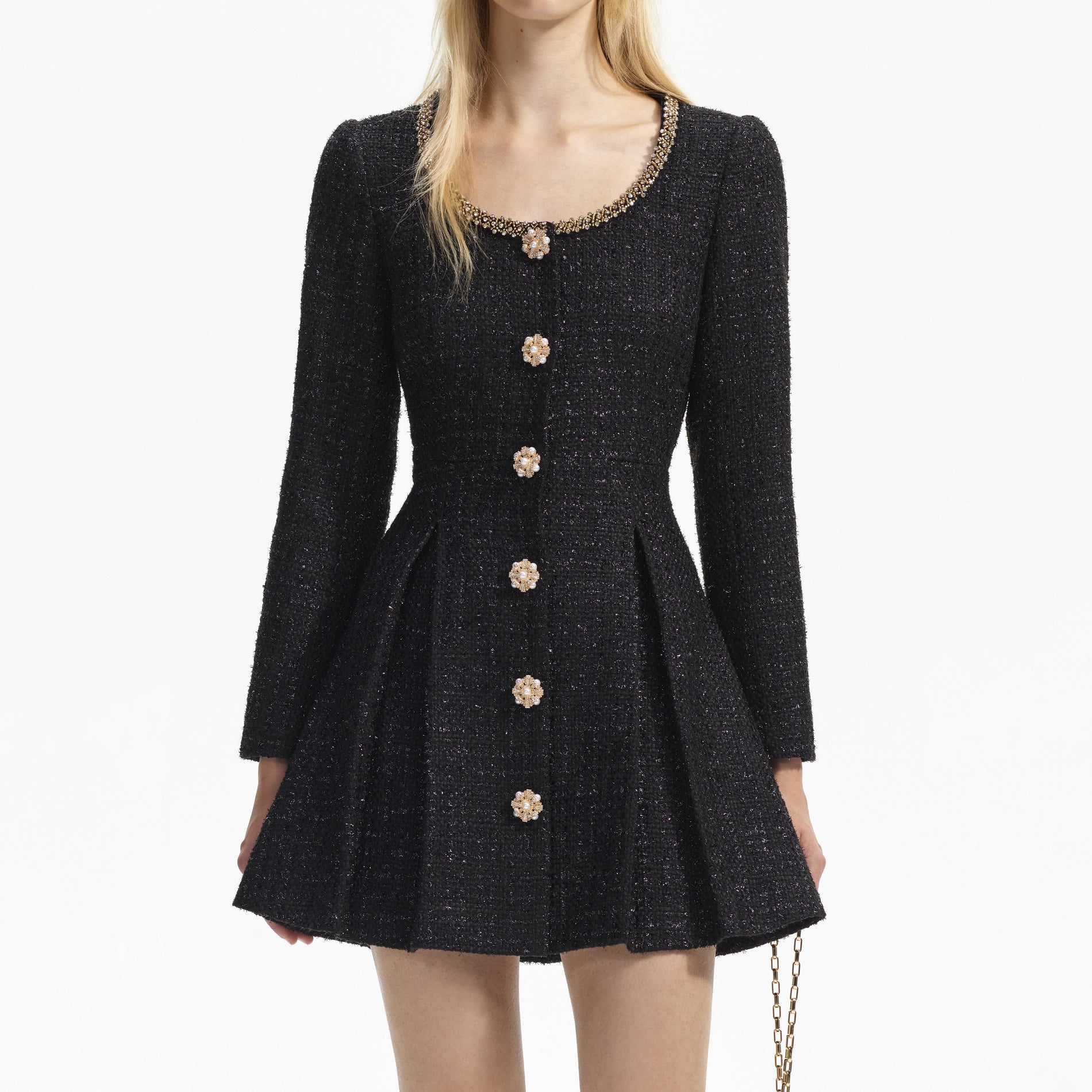 A close up of a woman wearing the Black Boucle Tailored Mini Dress