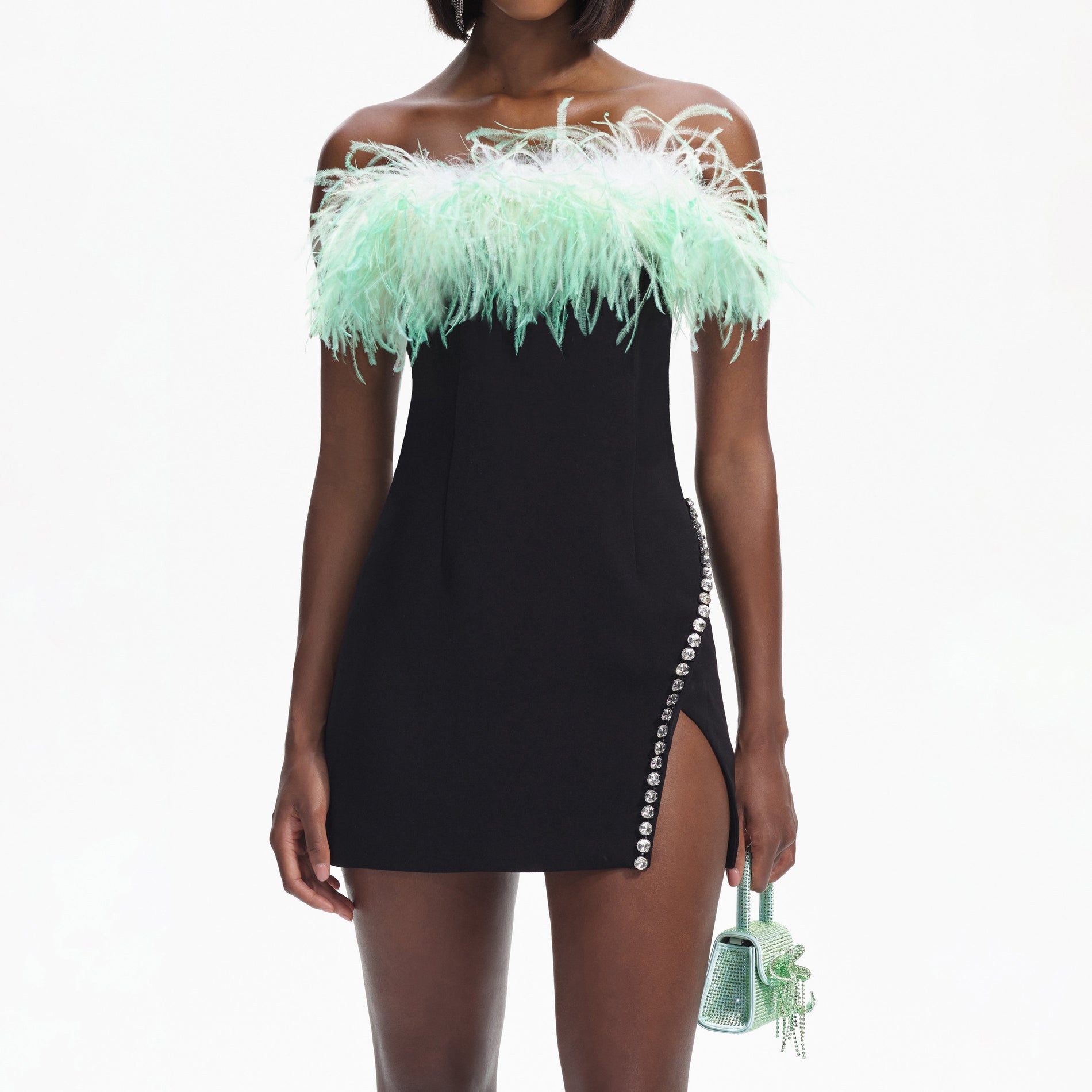 A close up of a woman wearing the Black Feather Mini Dress