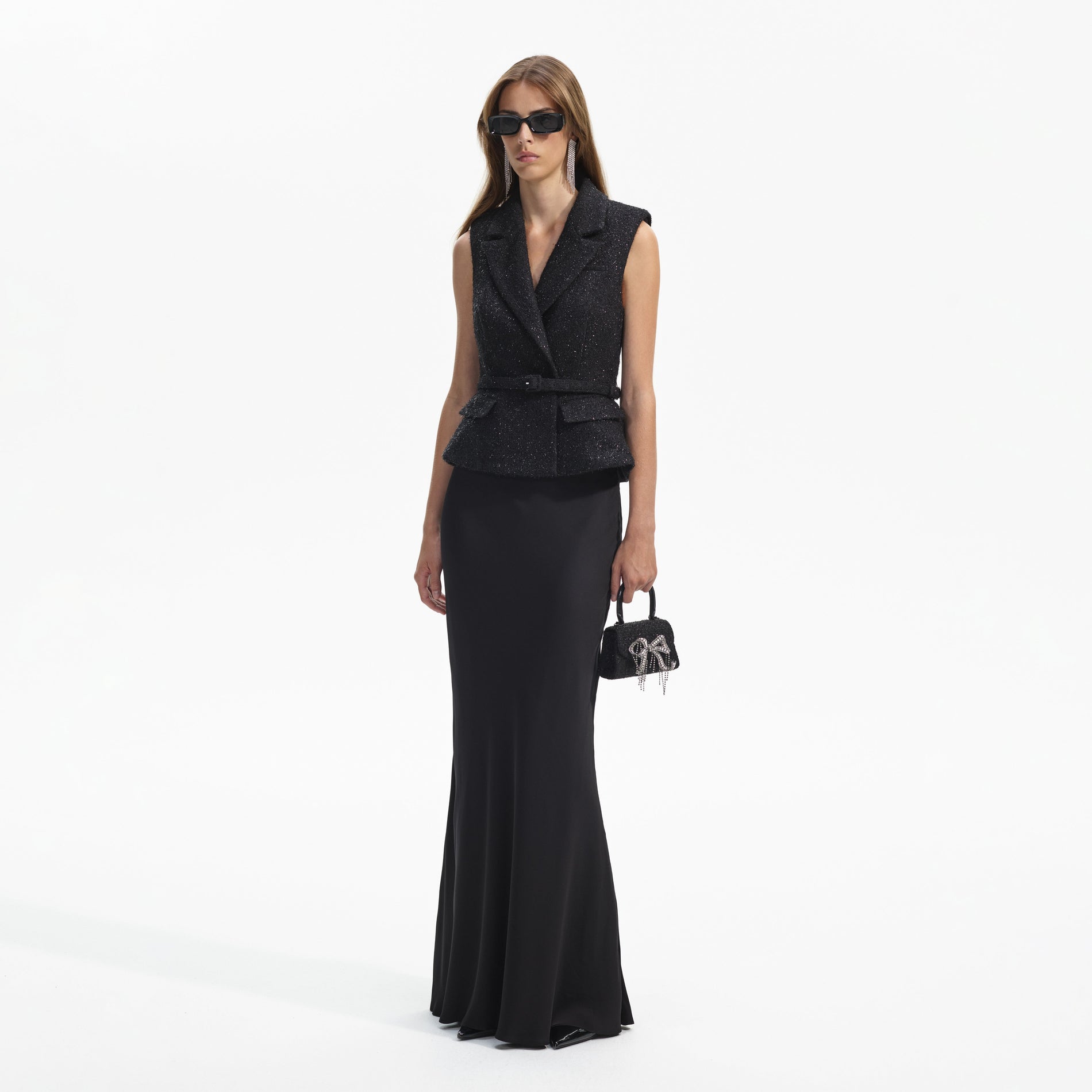 Side view of a woman wearing the Black Boucle Maxi Dress
