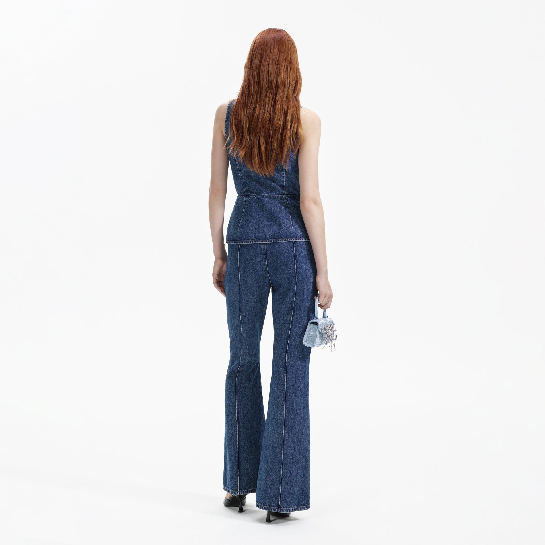 Back view of a woman wearing the Blue Denim Jumpsuit