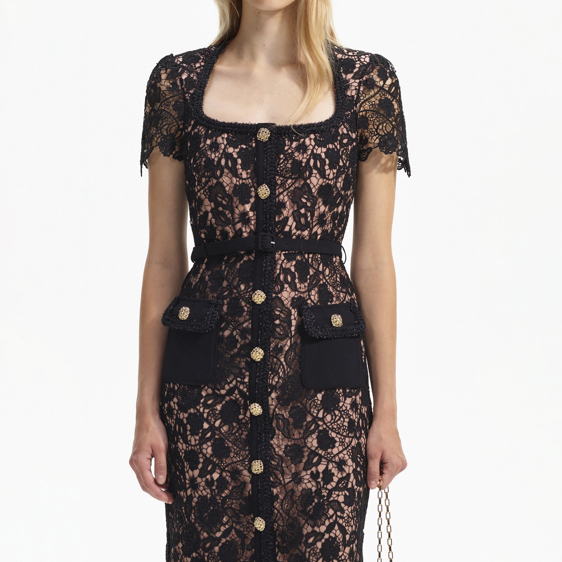 A close up of a woman wearing the Black Guipure Lace Short Sleeve Midi Dress