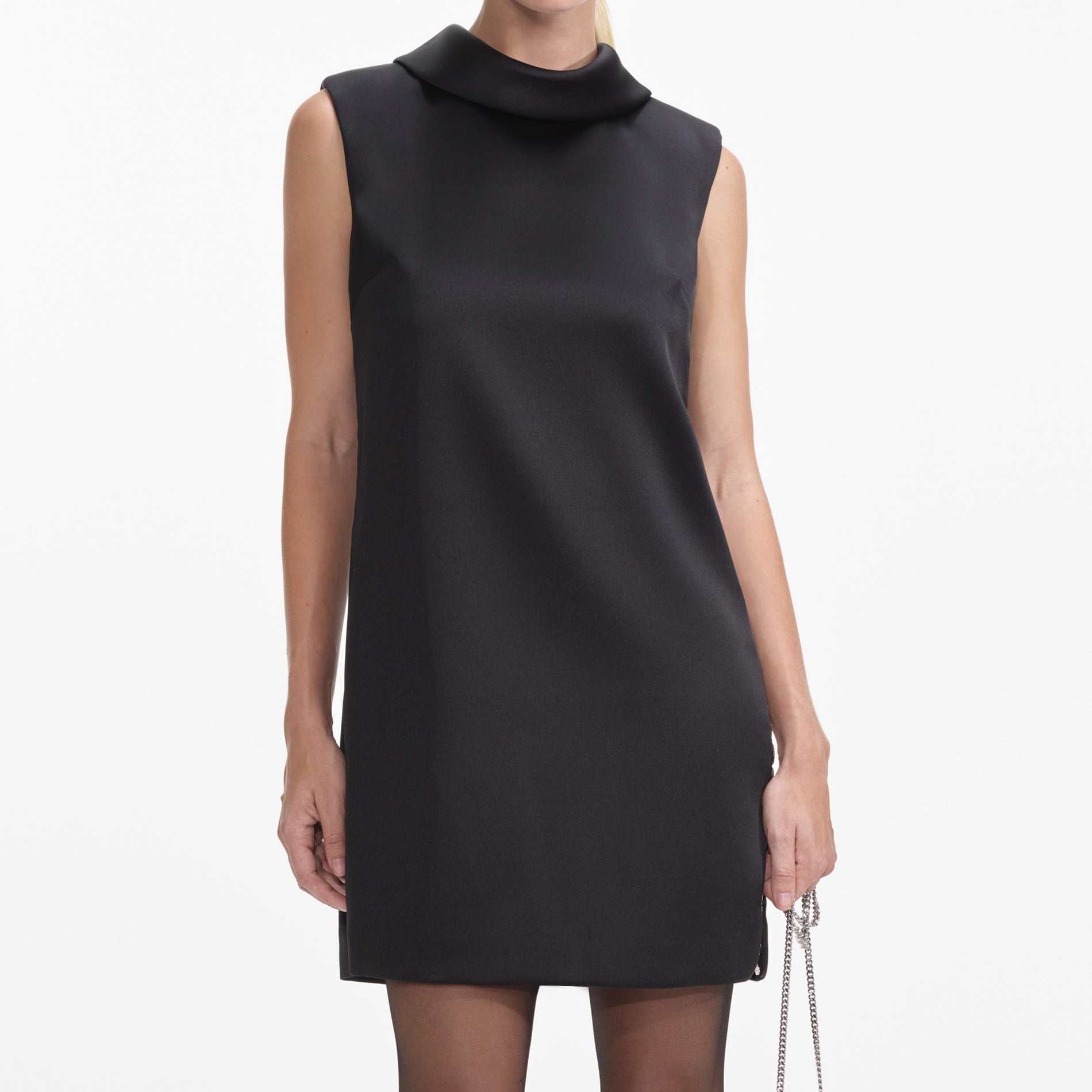 A close up of a woman wearing the Black Satin Chain Detail Mini Dress