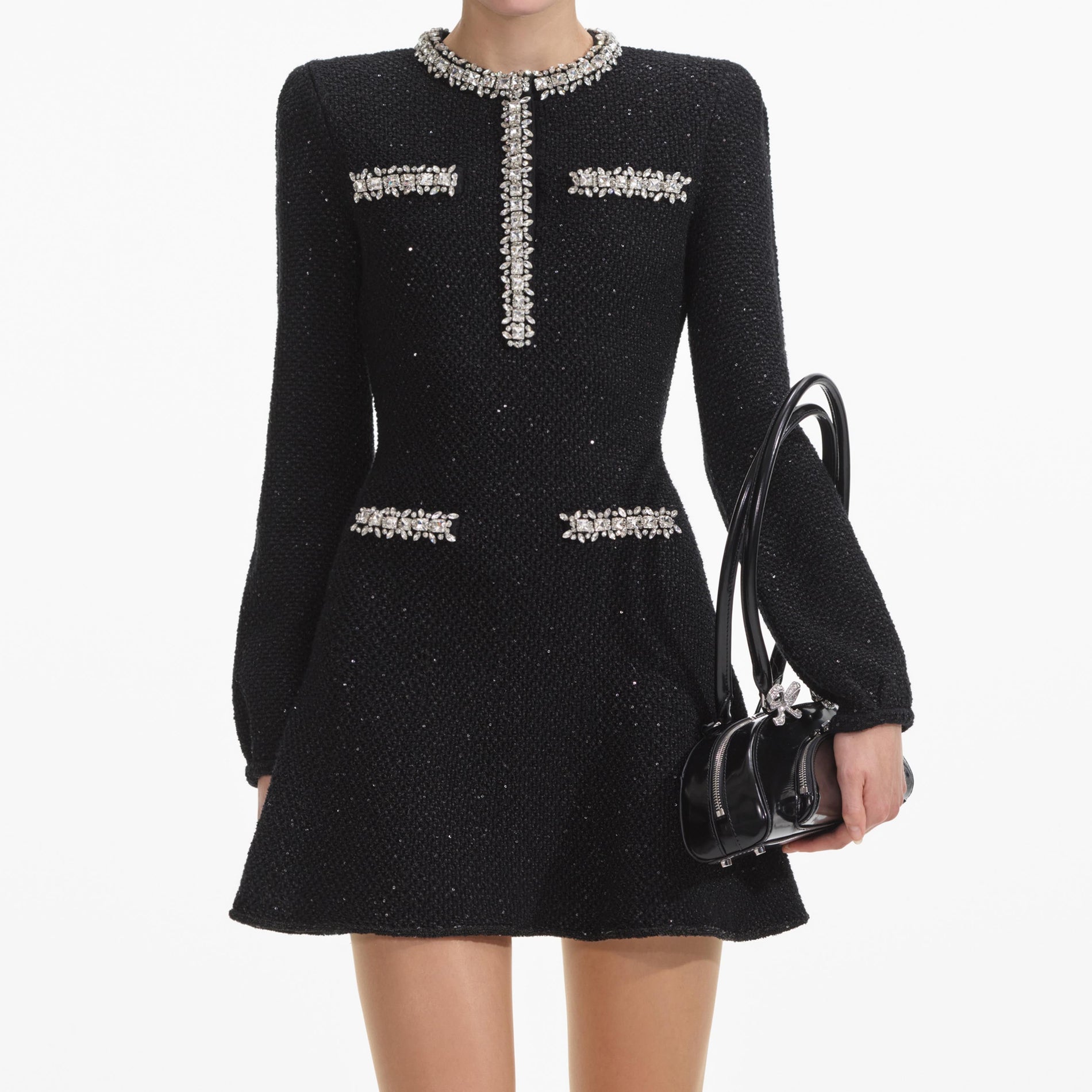 A close up of a woman wearing the Black Sequin Knit Mini Dress