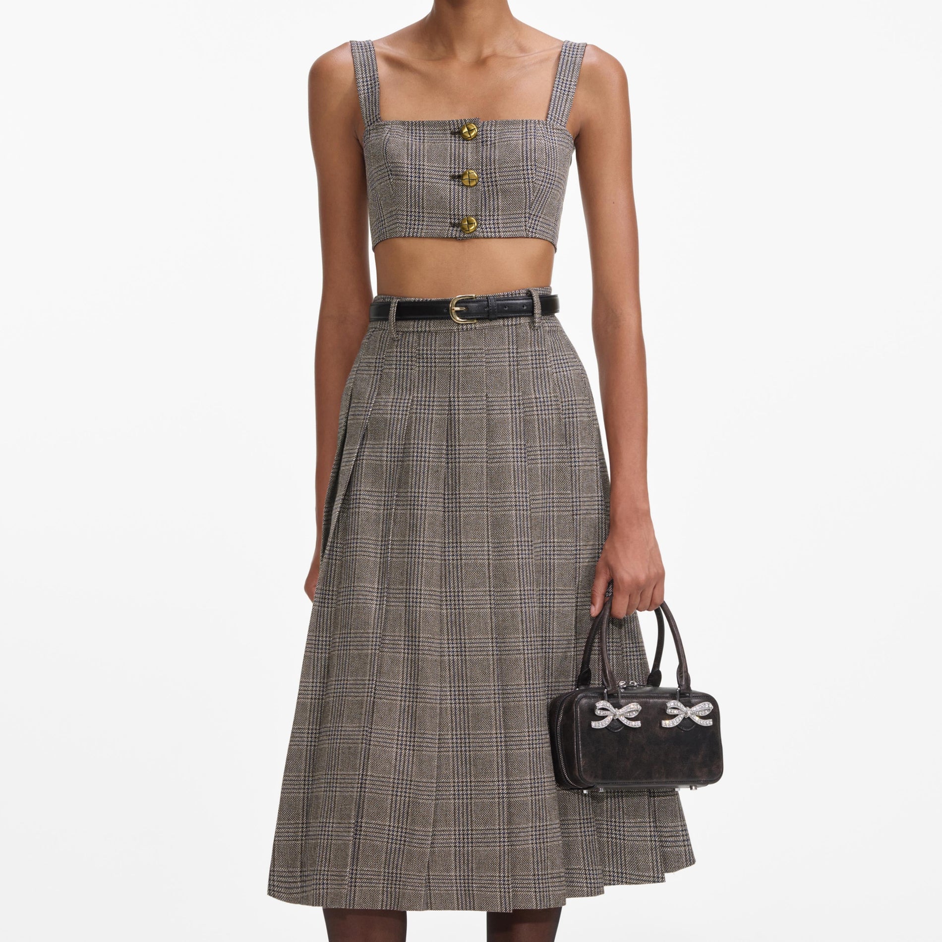 A close up of a woman wearing the Brown Check Pleated Midi Skirt