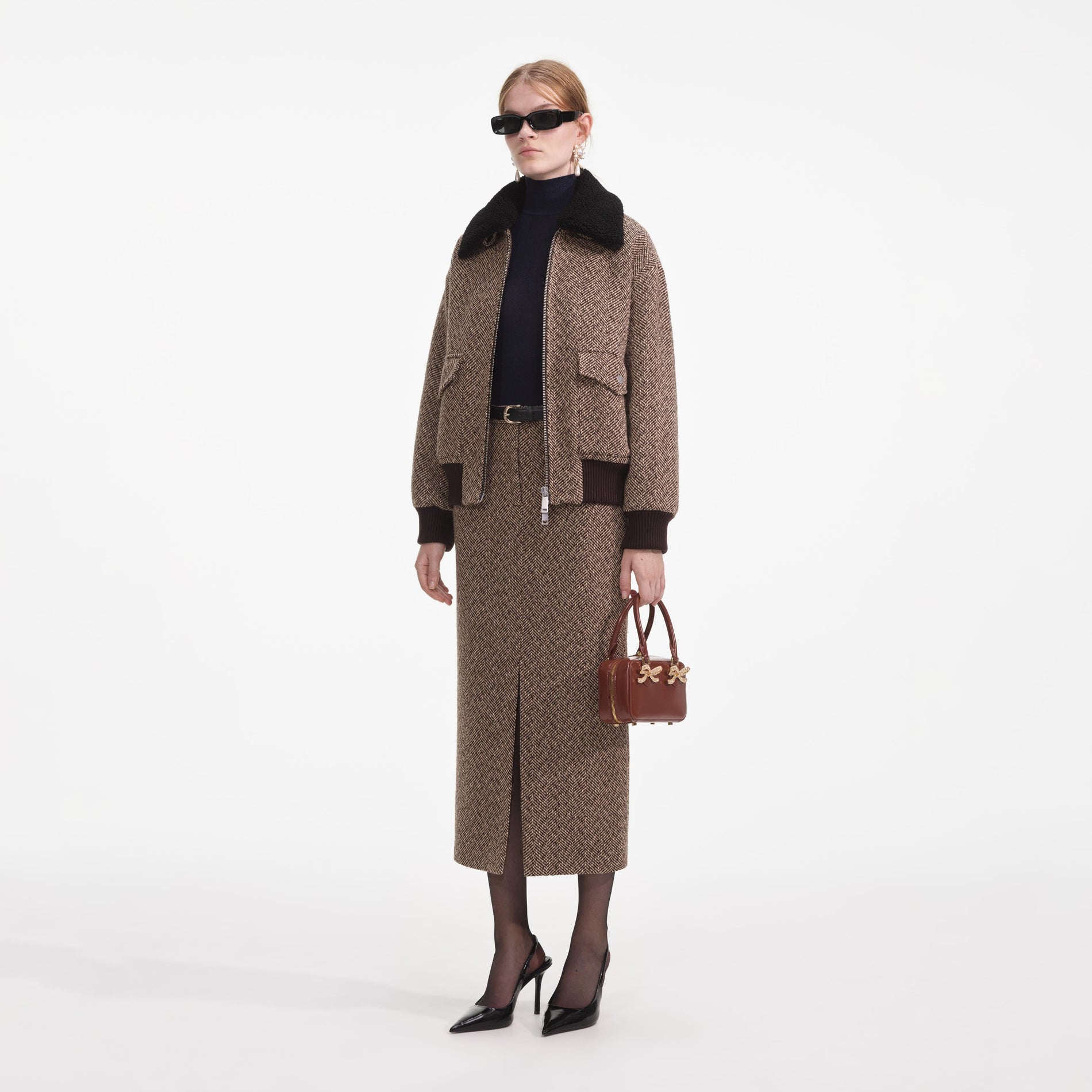 Side view of a woman wearing the Brown Herringbone Midi Skirt