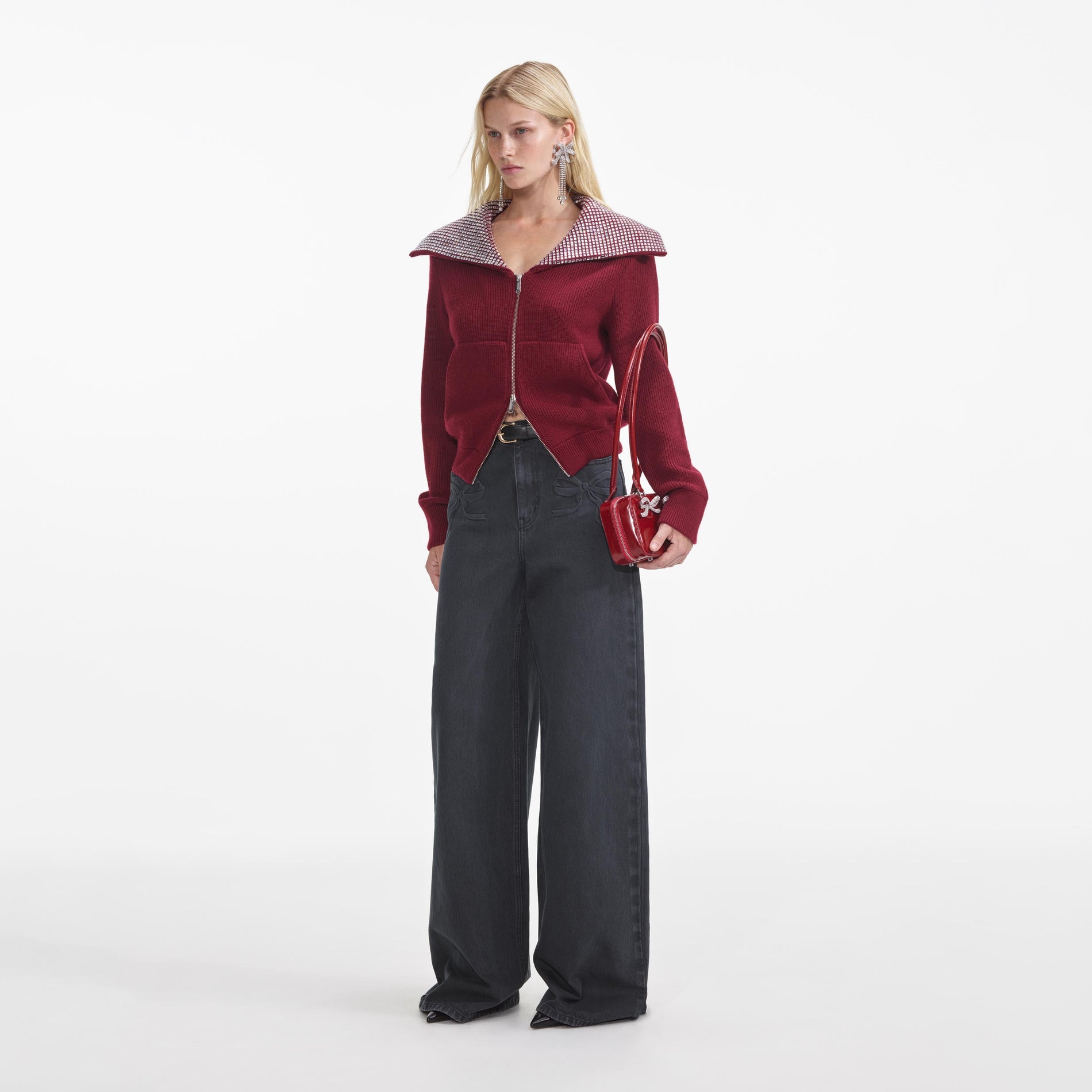 Side view of a woman wearing the Burgundy Diamante Collar Knit Jacket