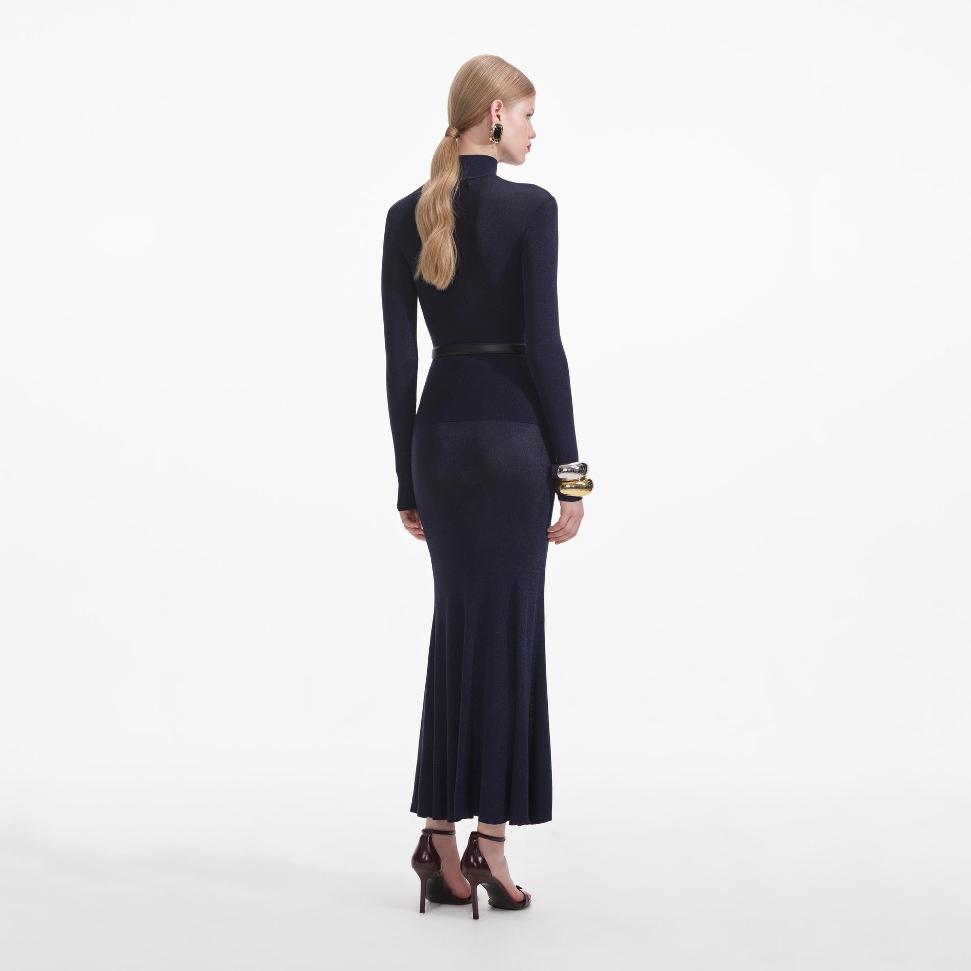 Back view of a woman wearing the Navy Viscose Knit Maxi Skirt