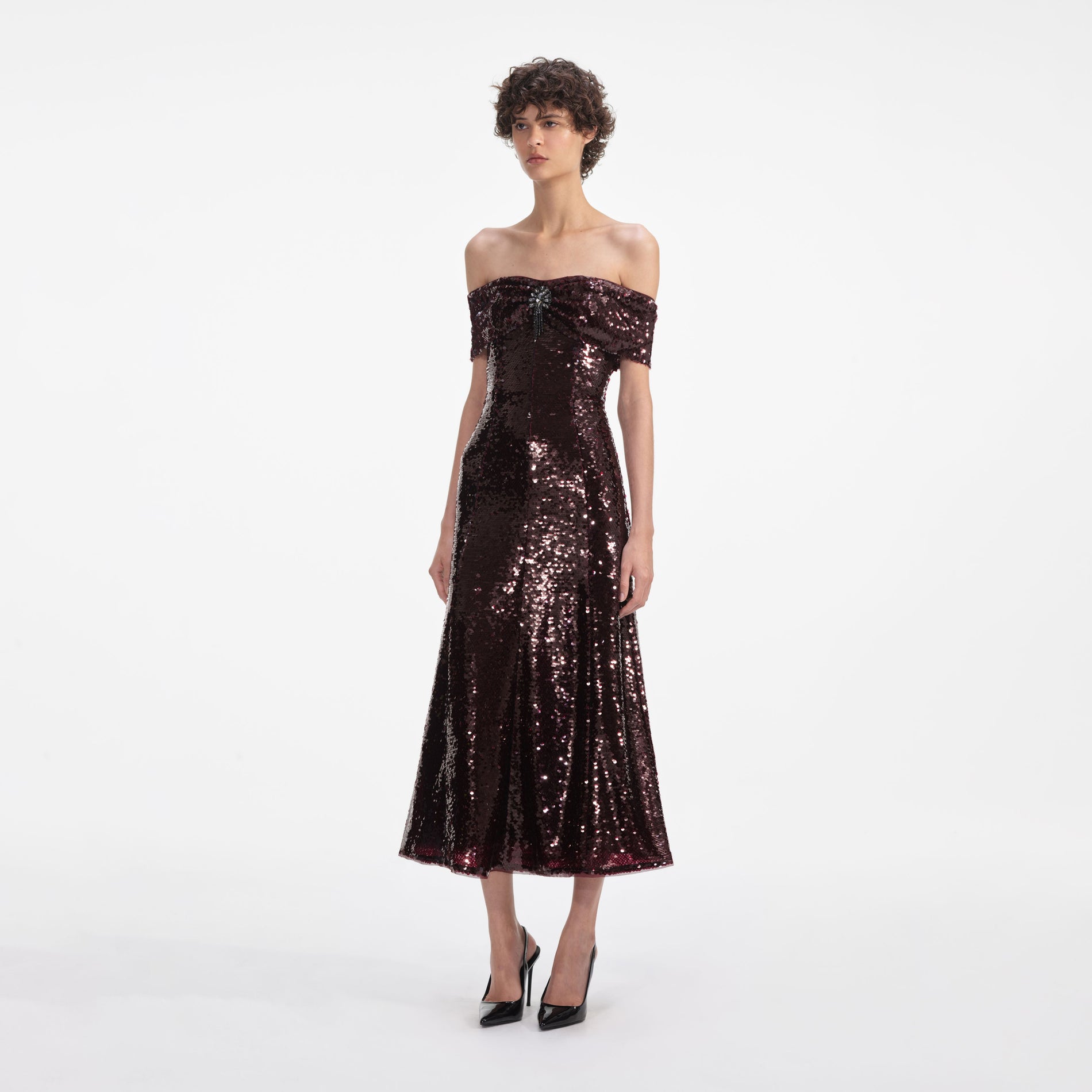 Side view of a woman wearing the Brown Sequin Off Shoulder Midi Dress