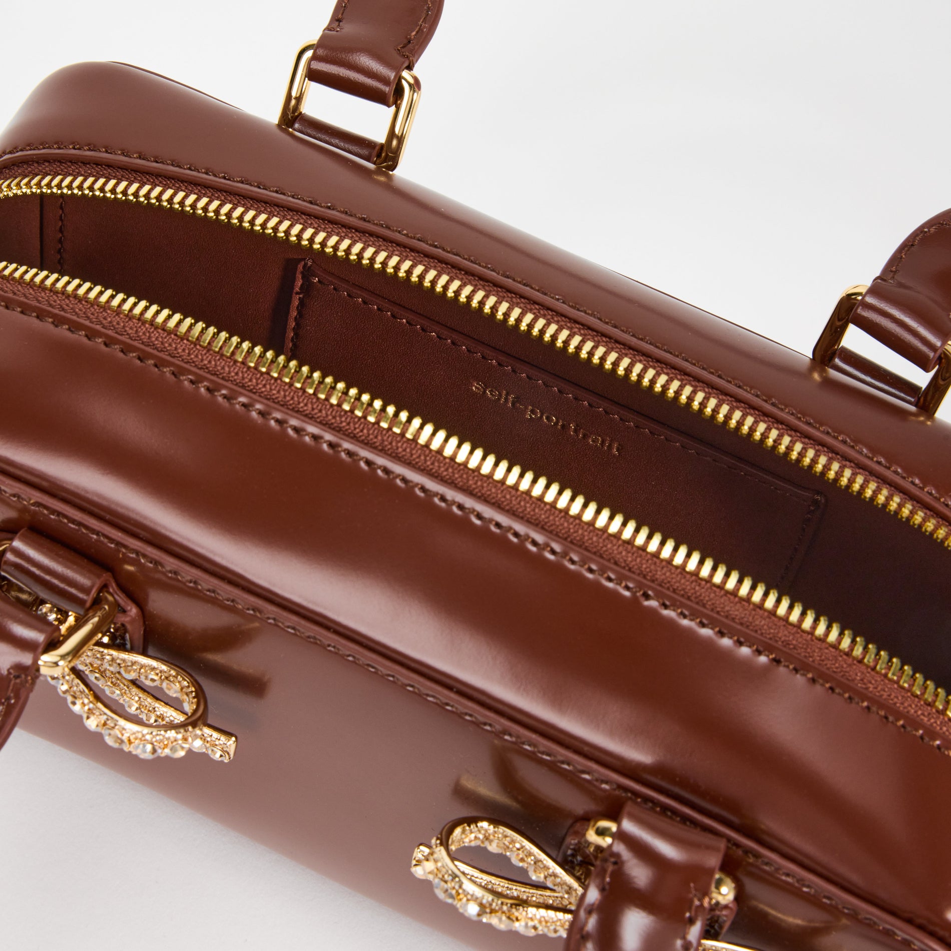 A close up of a woman wearing the Brown Leather Mini Tote Bag