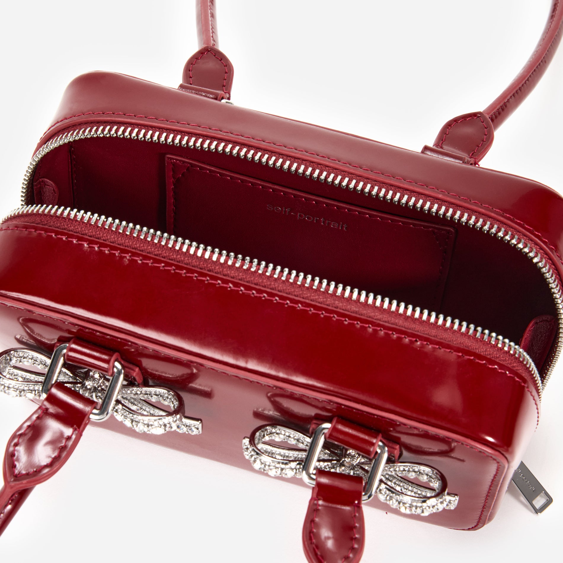 A close up of a woman wearing the Burgundy Leather Shoulder Bag