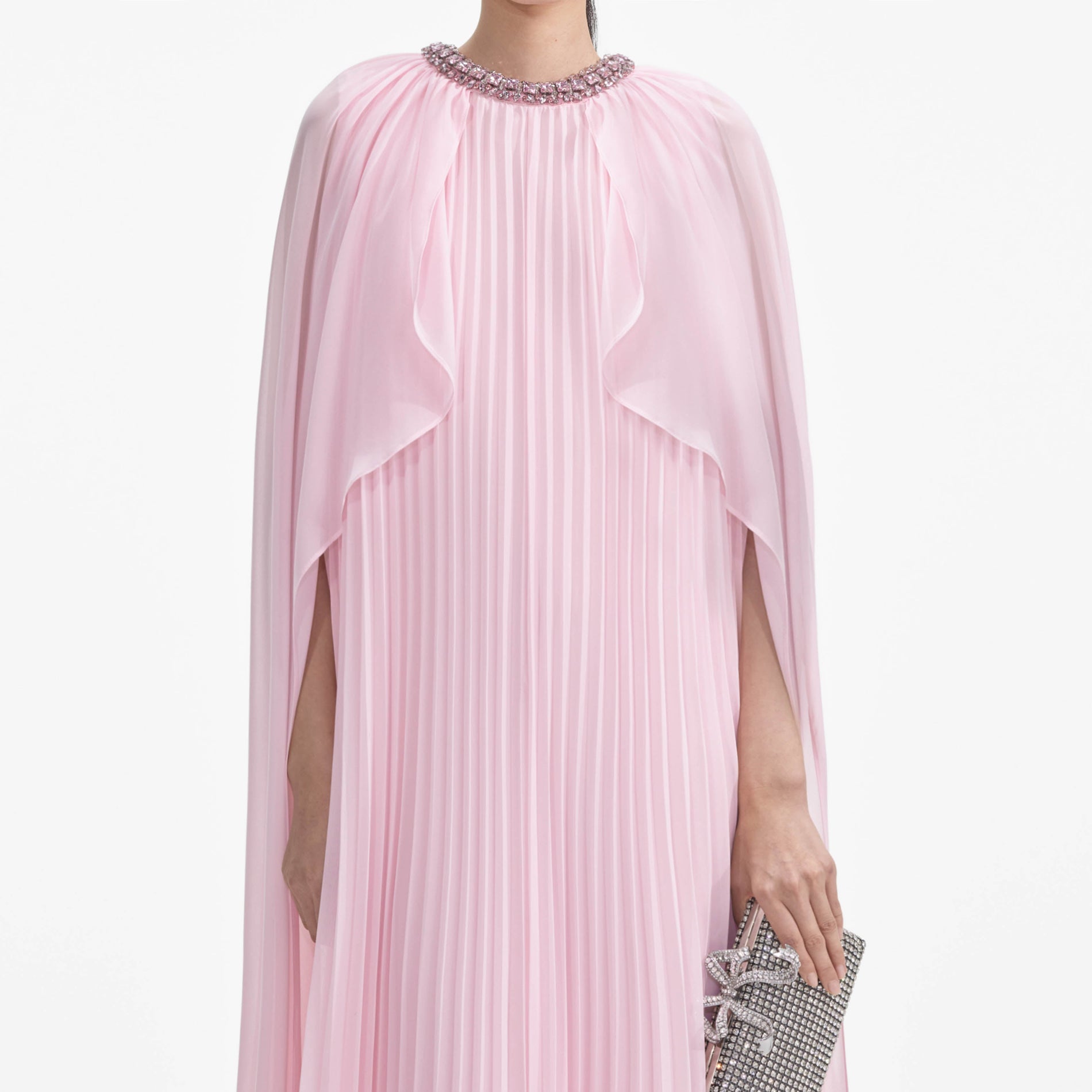 A close up of a woman wearing the Pink Chiffon Cape Midi Dress