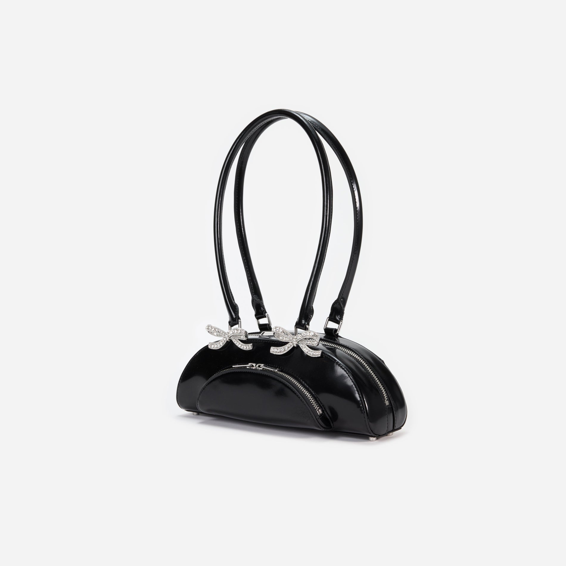 Side view of a woman wearing the Black Leather Curved Shoulder Bag
