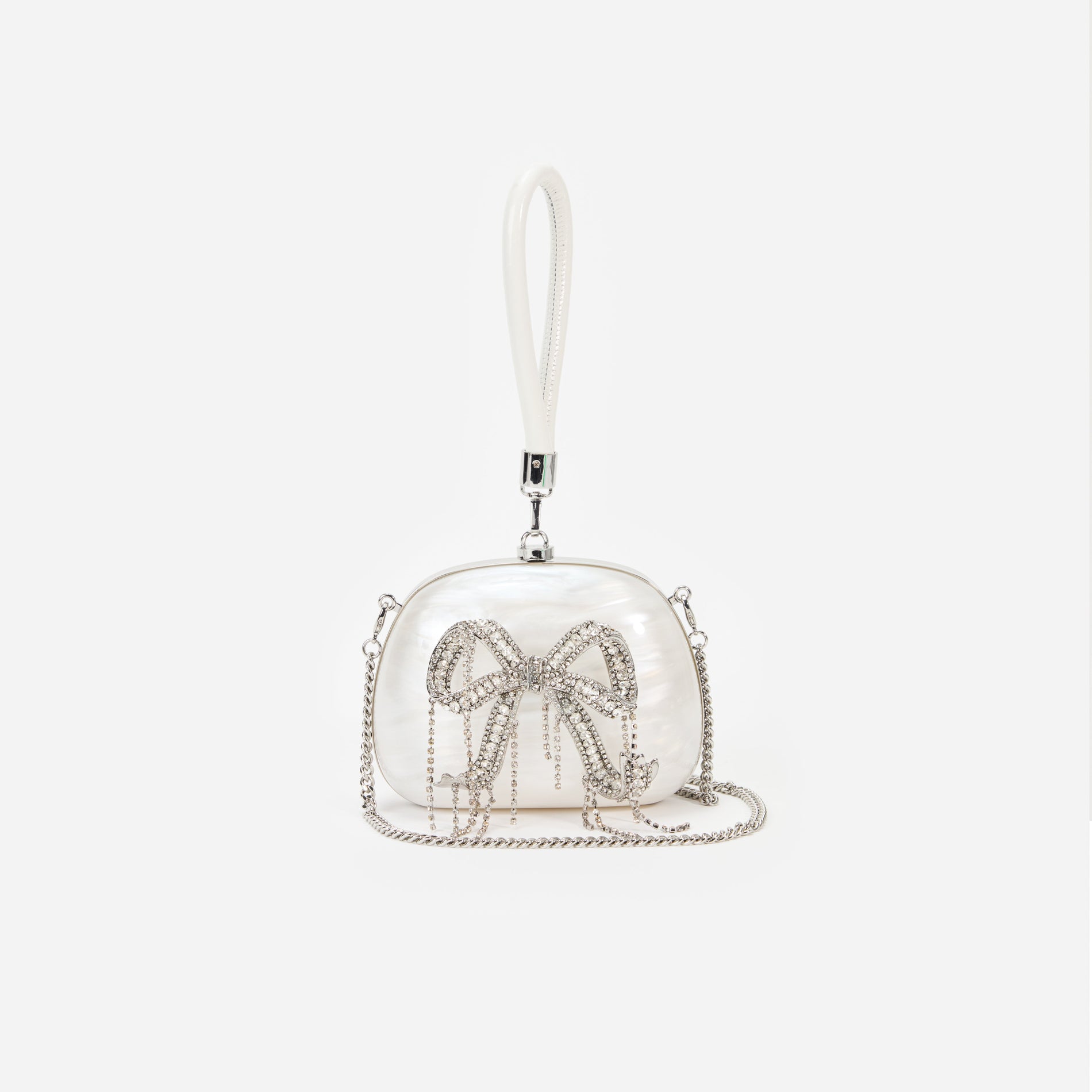 A close up of a woman wearing the Pearl Top Handle Clutch Bag